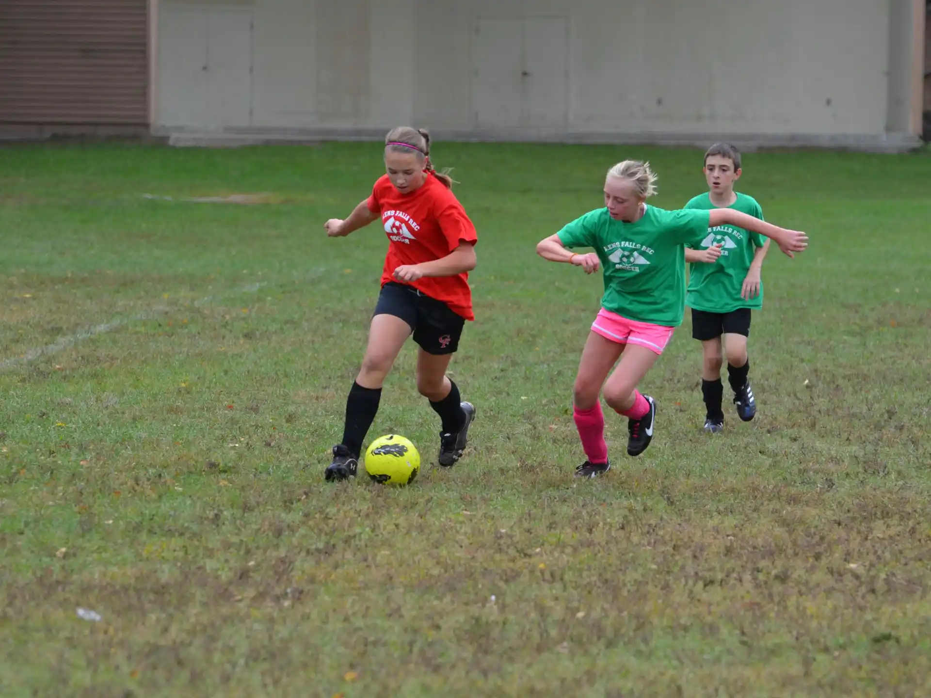 girls playing football on a field