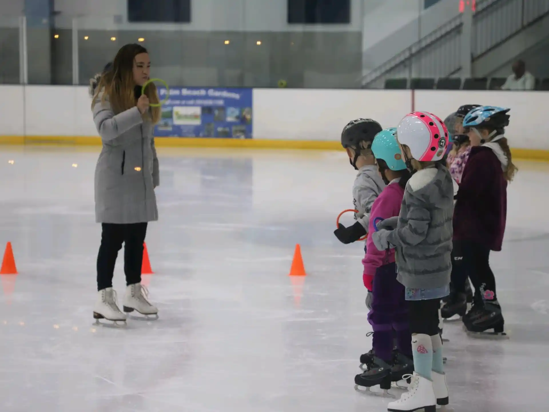 a person and a group of kids wearing ice skates