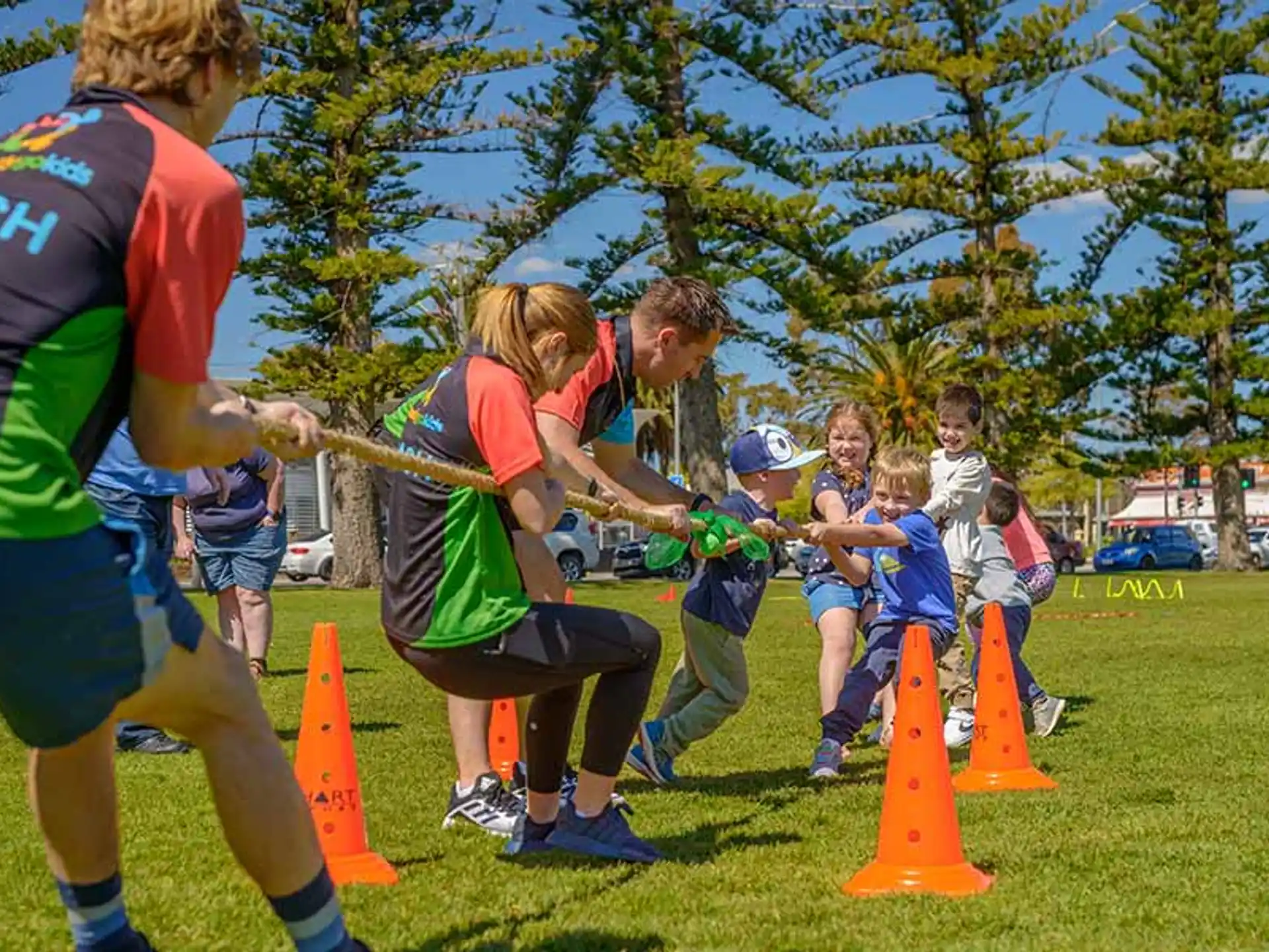 a group of people playing tug of war