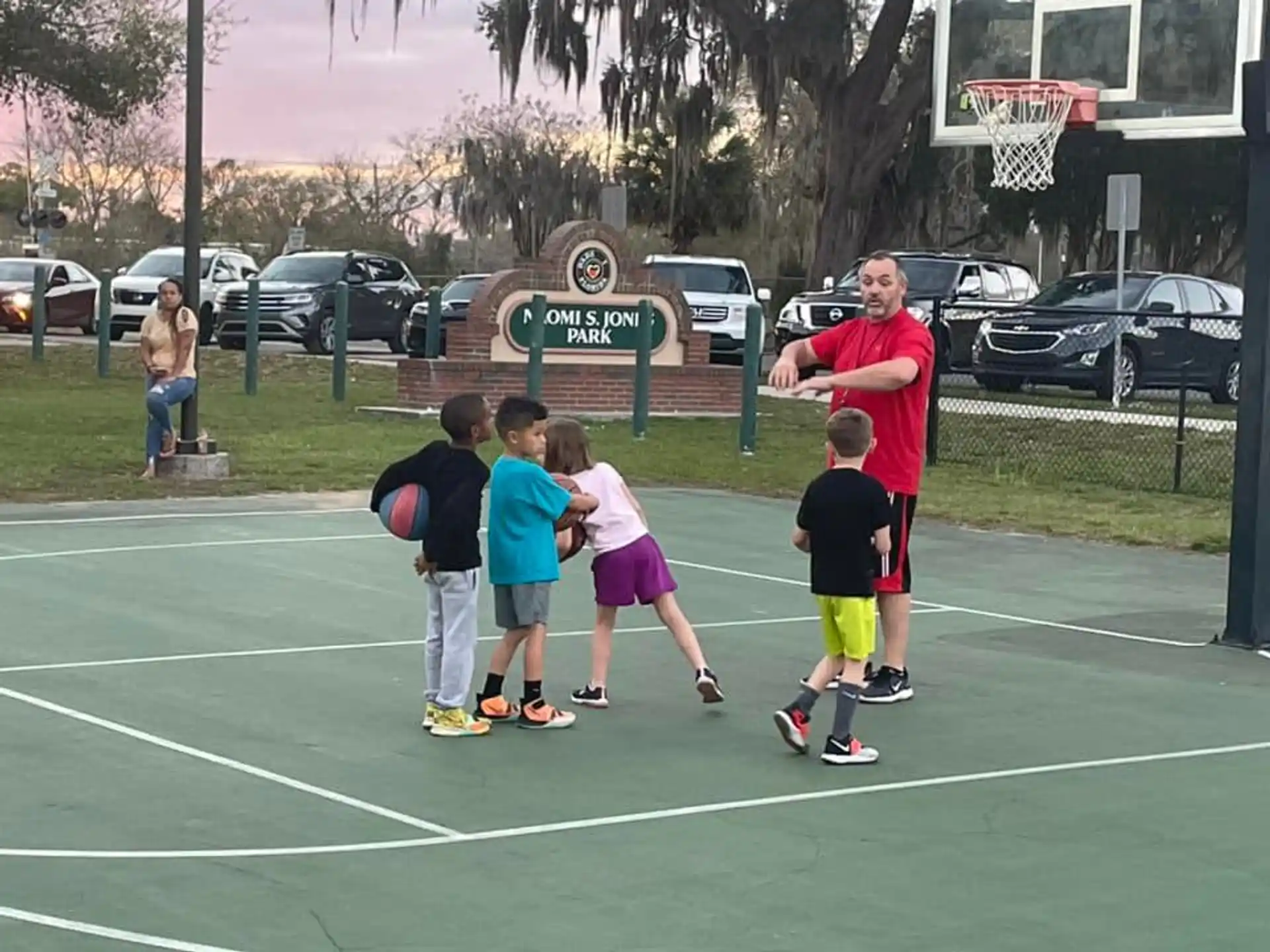 a group of kids playing basketball