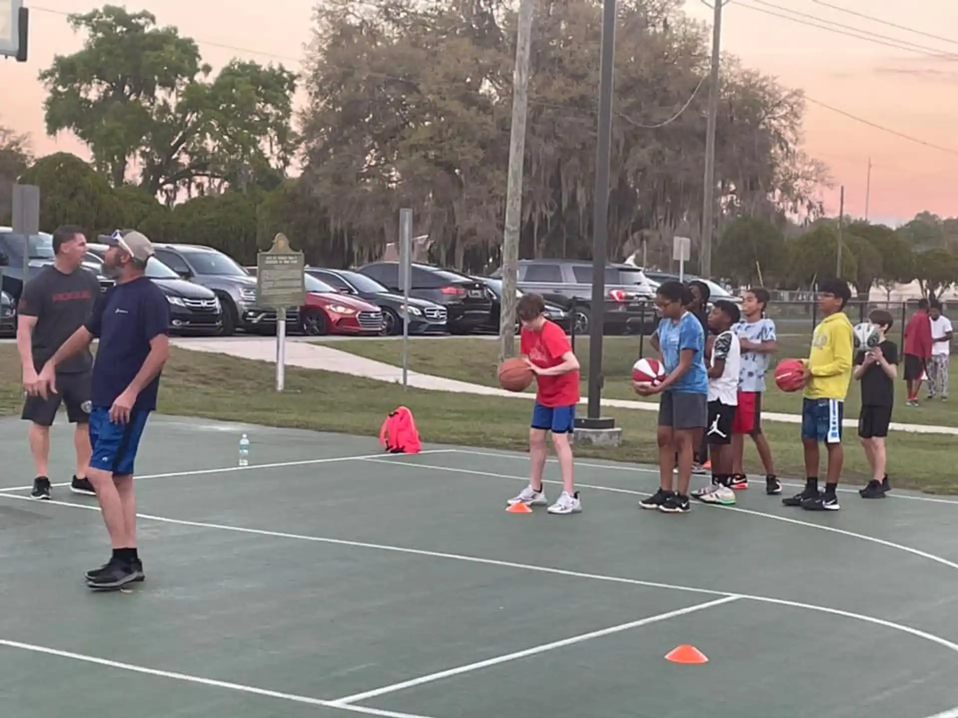 a group of people playing basketball