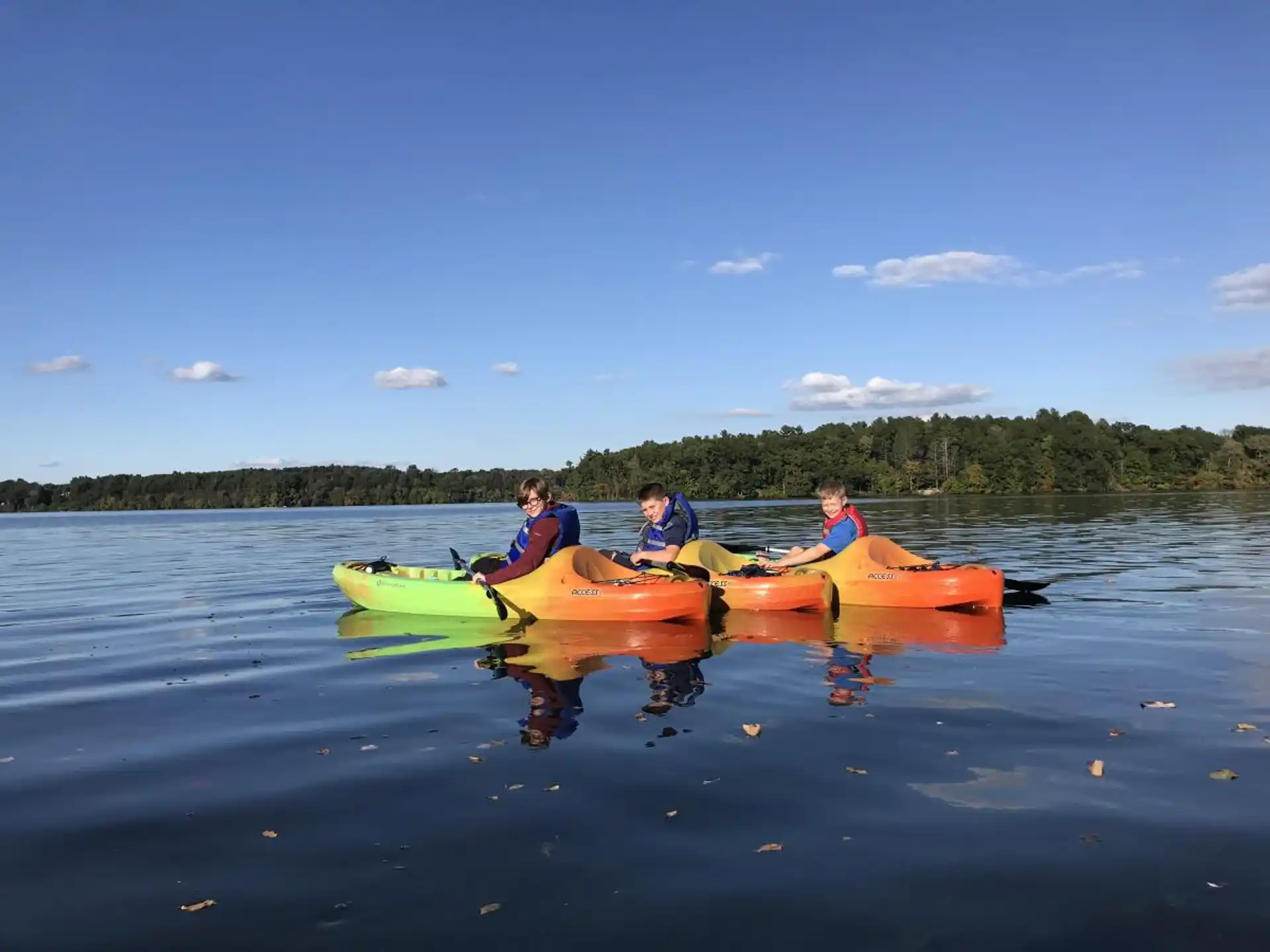 a group of people in canoes on a lake