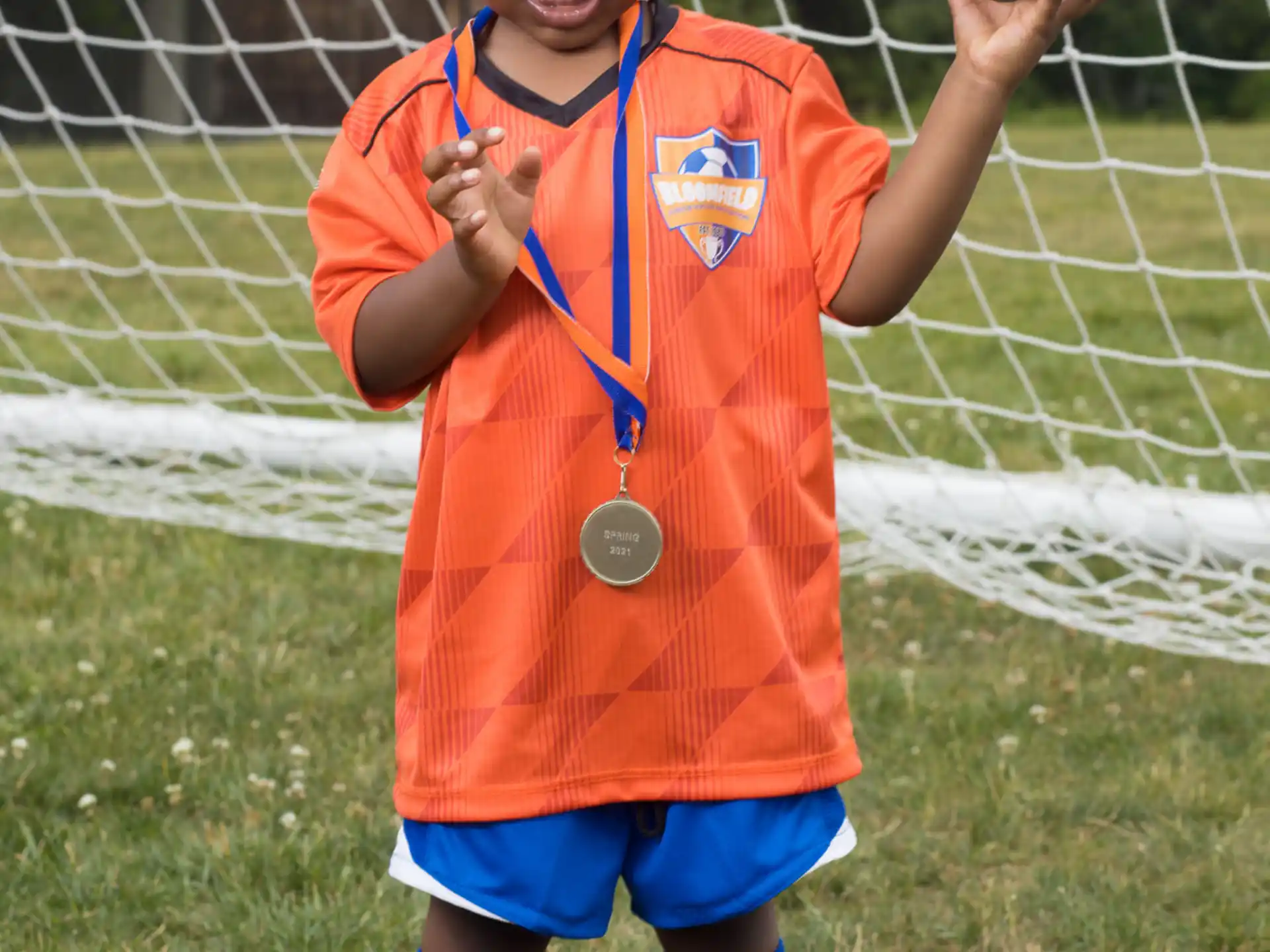 a boy holding a football ball