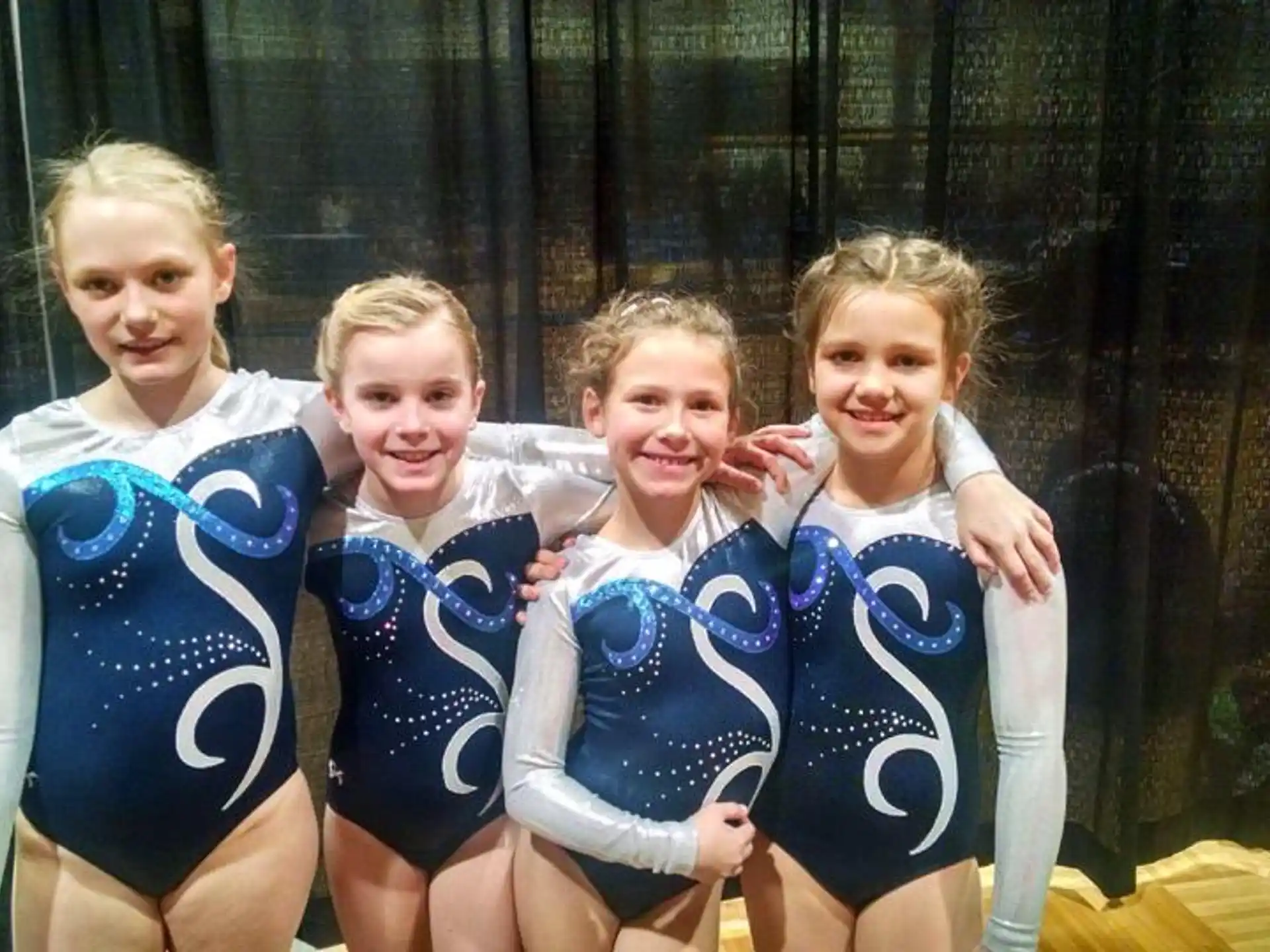 a group of girls in athletic uniforms