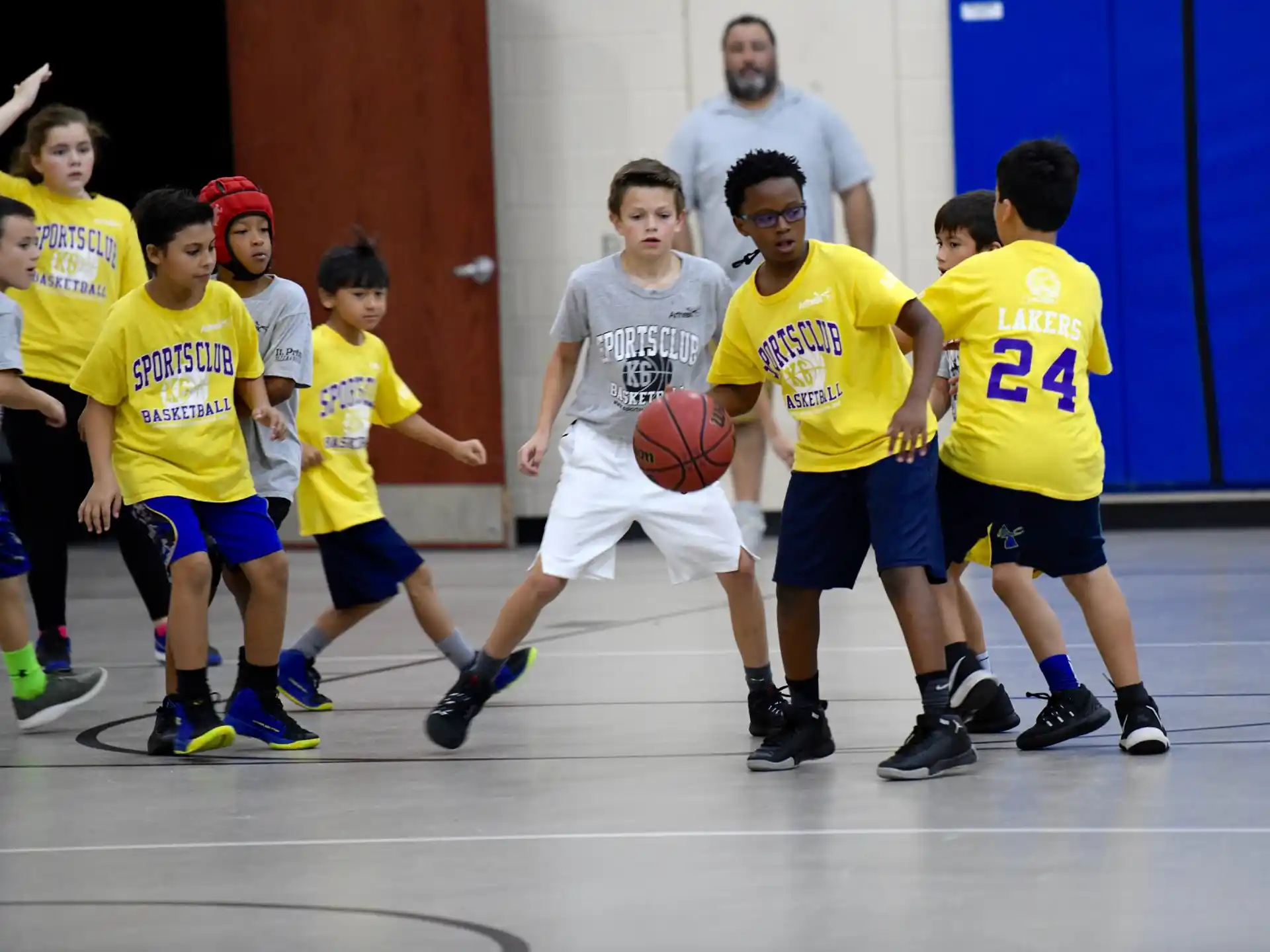 a group of kids playing basketball