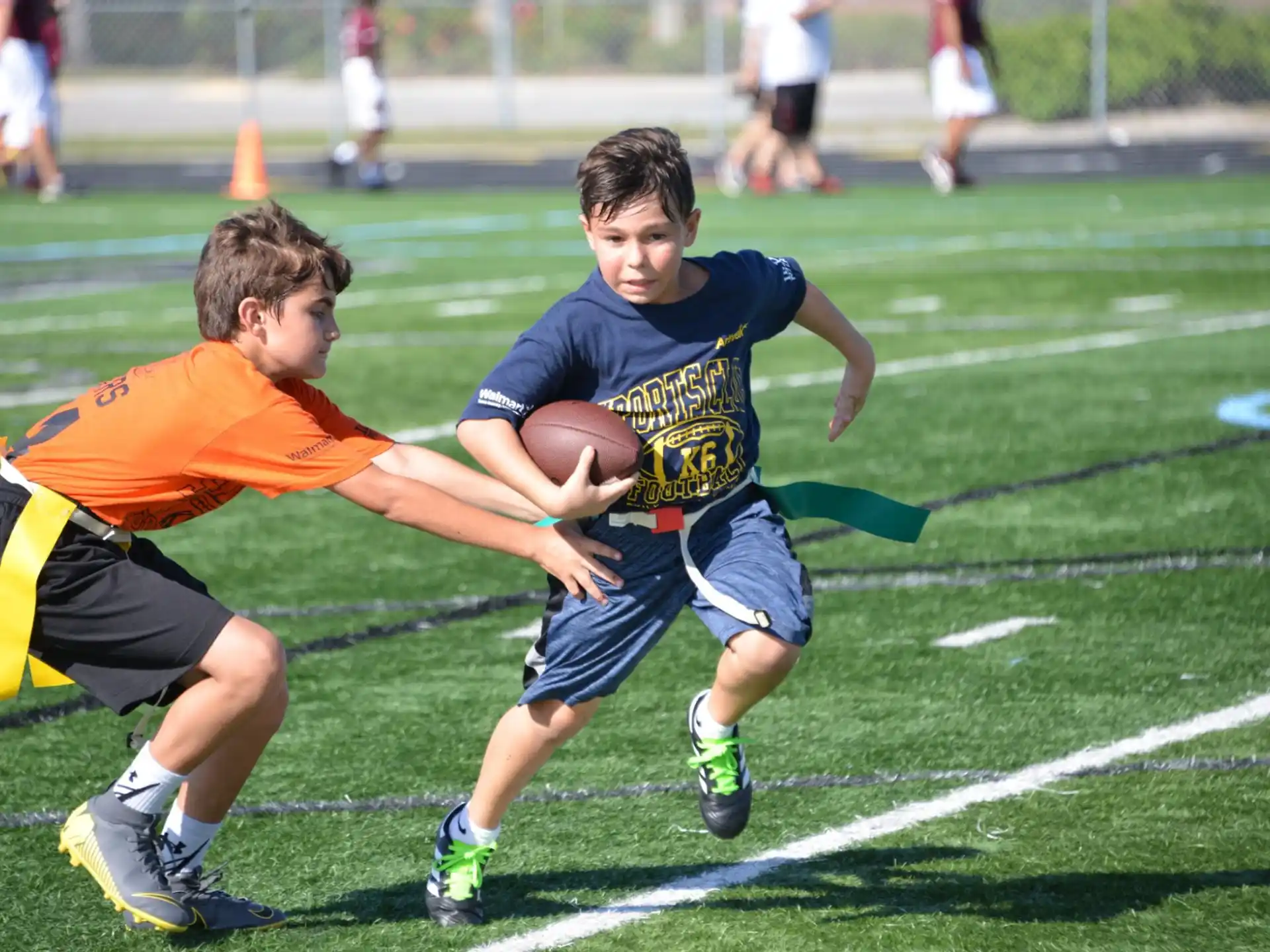 boys playing football on a field