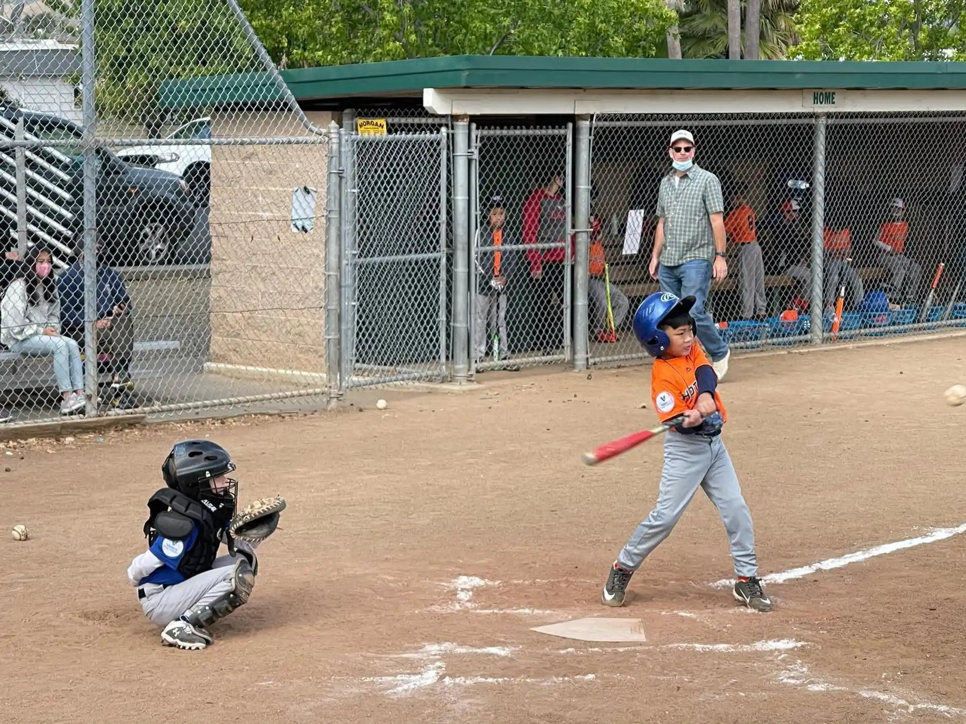 a kid swinging a baseball bat