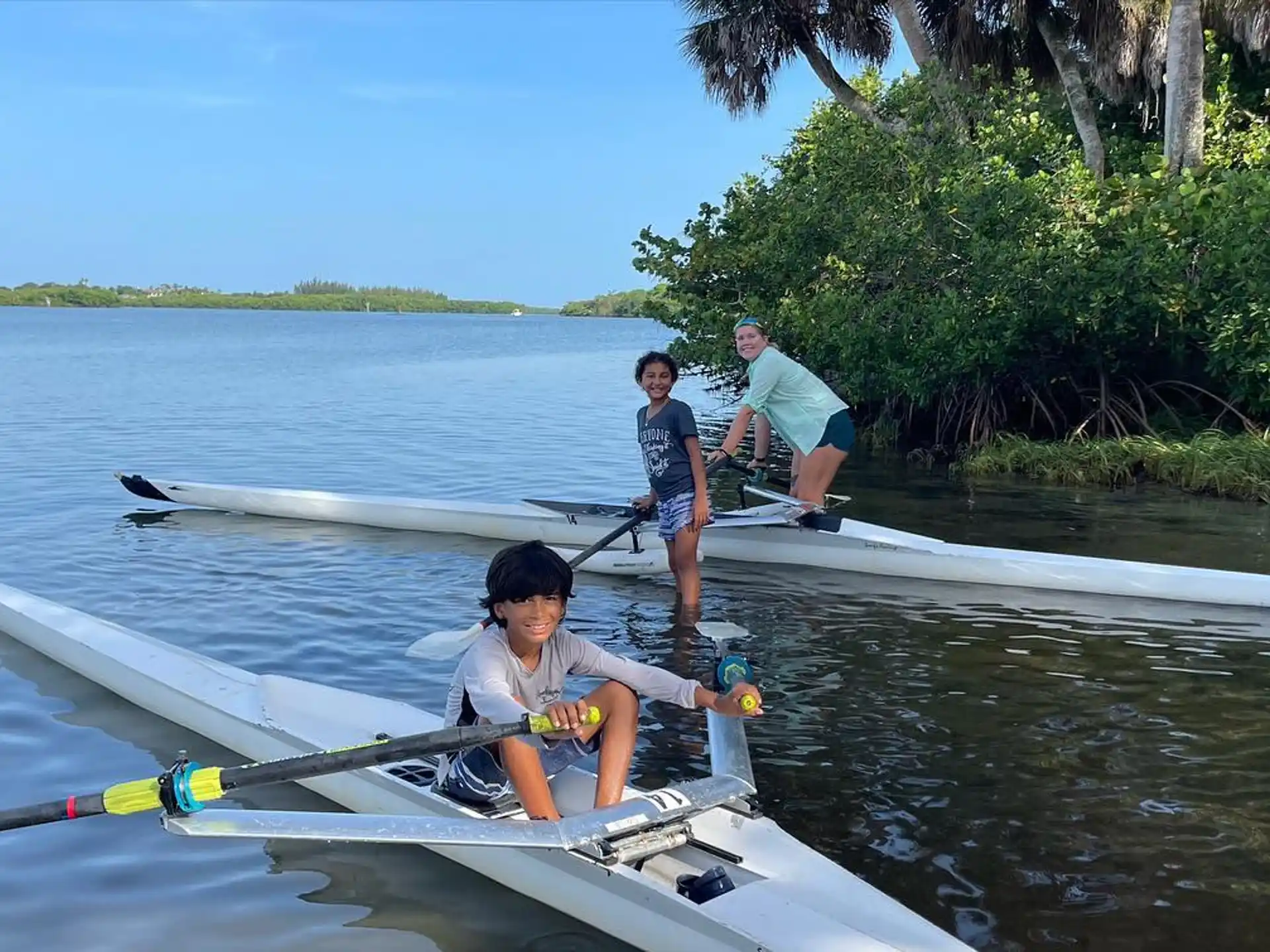 a group of people rowing a boat