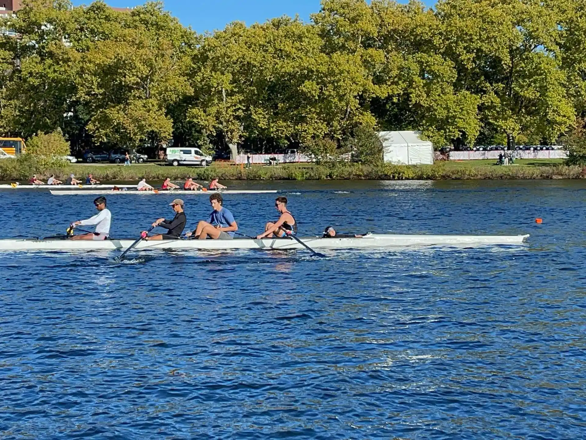 a group of people rowing a boat