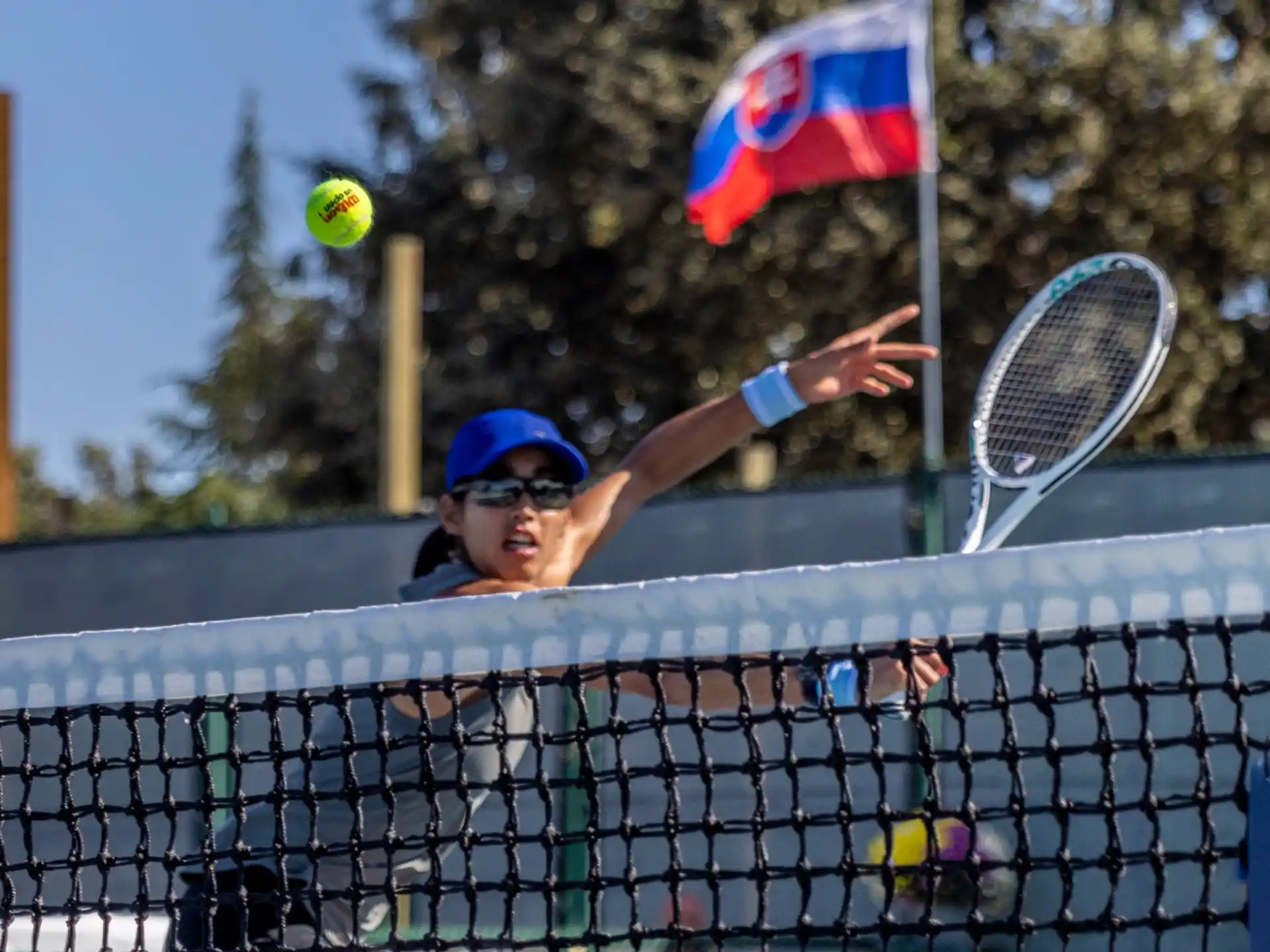 a person hitting a ball with a tennis racket