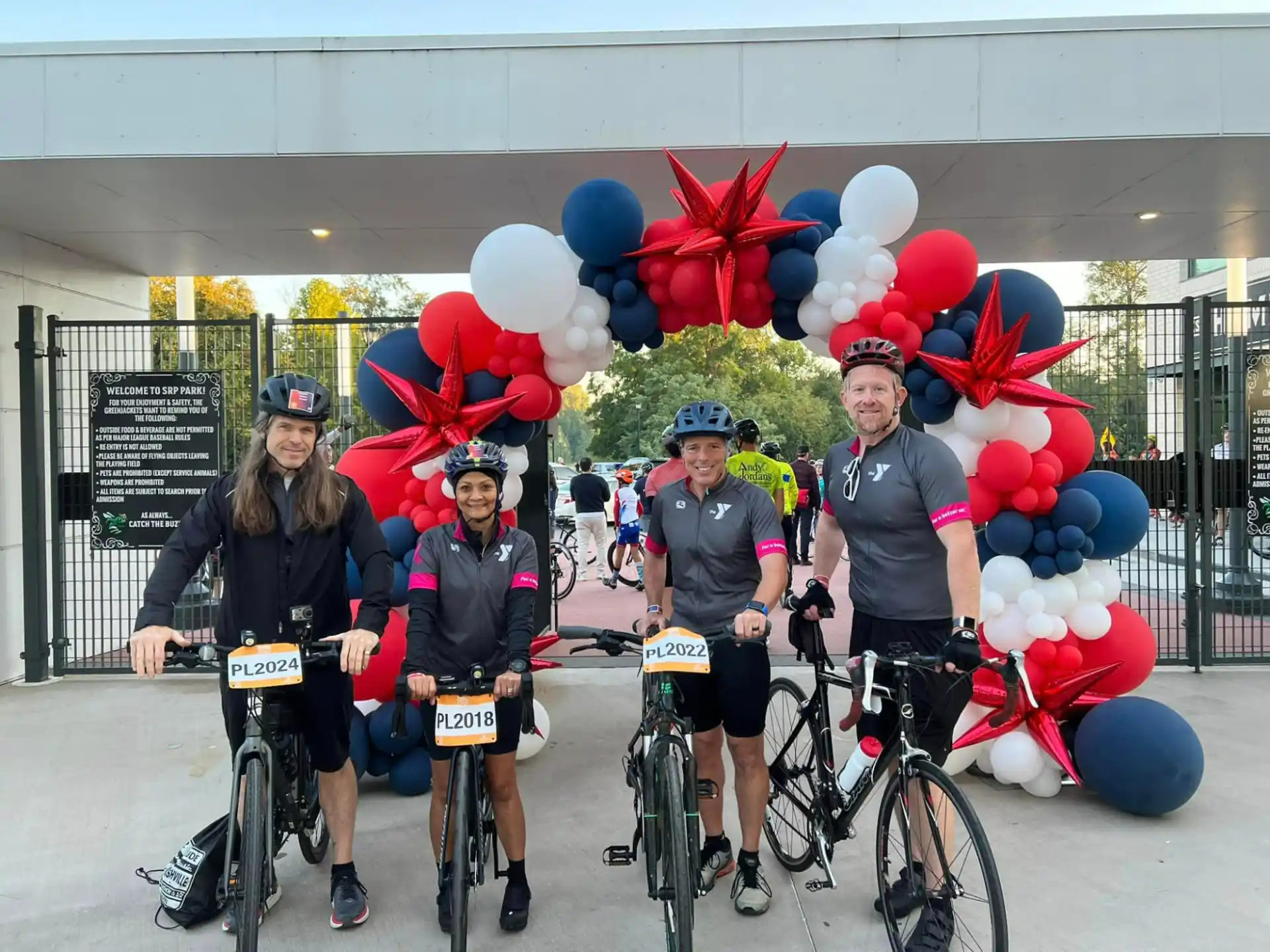 a group of people with bicycles and balloons