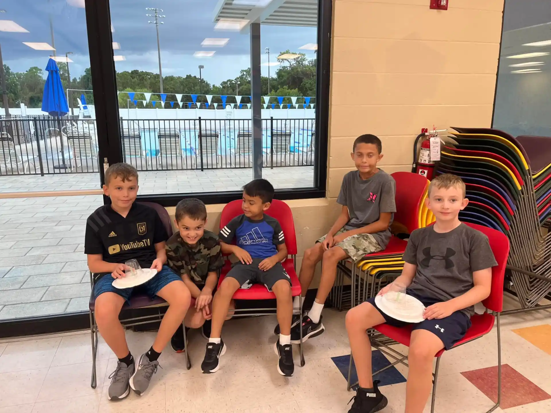 a group of boys sitting on a bench