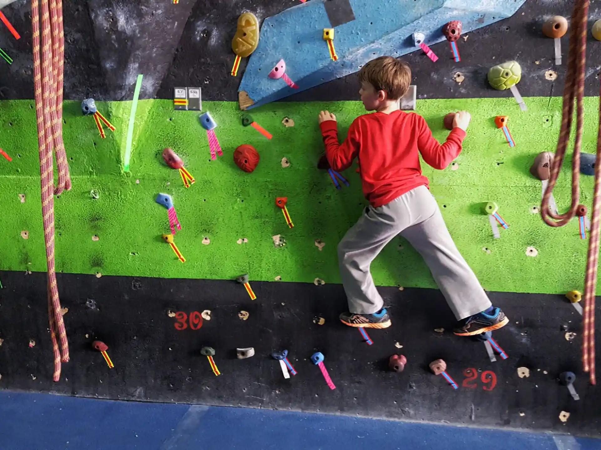 a boy climbing a rock wall