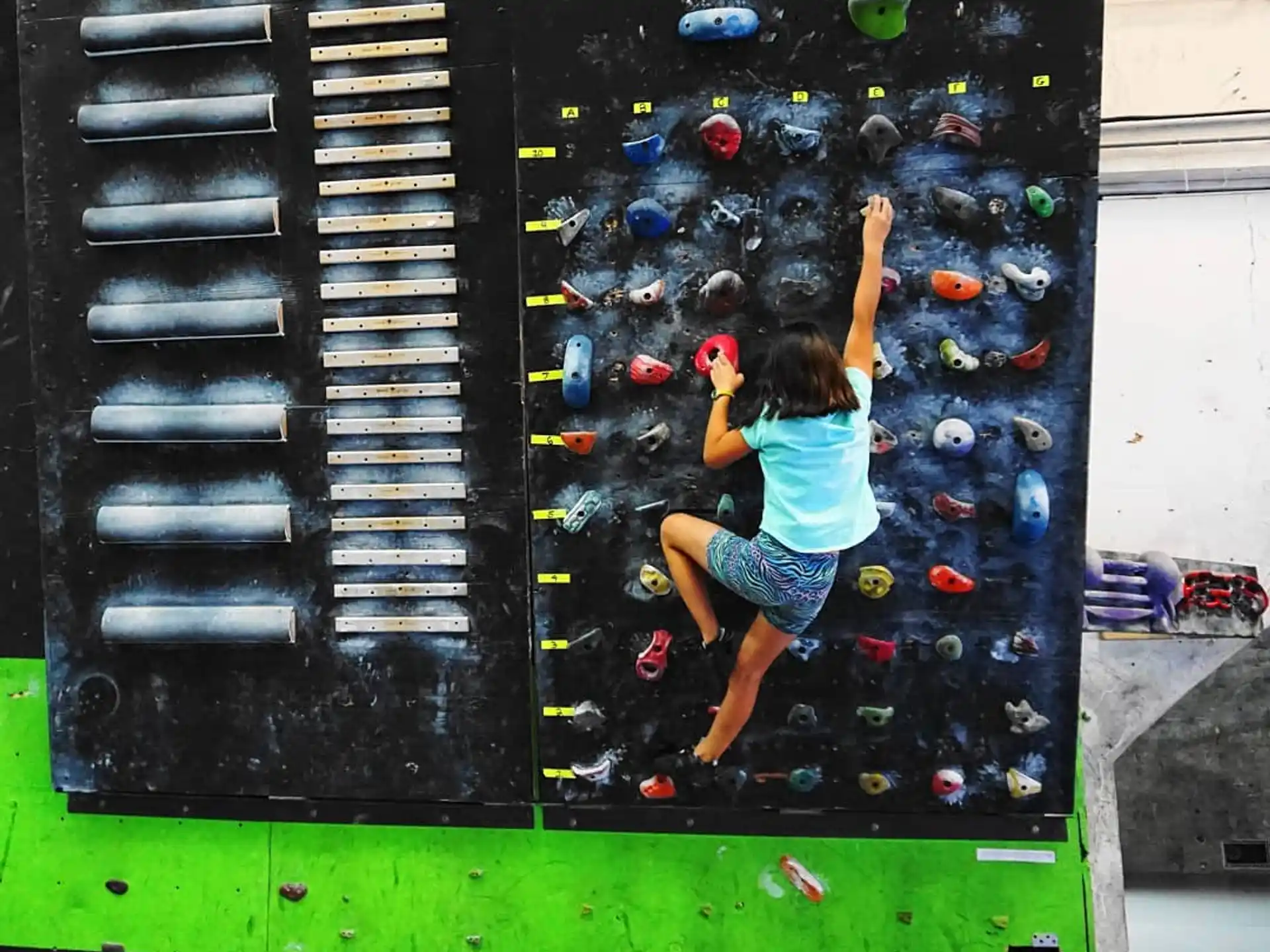a girl climbing a wall