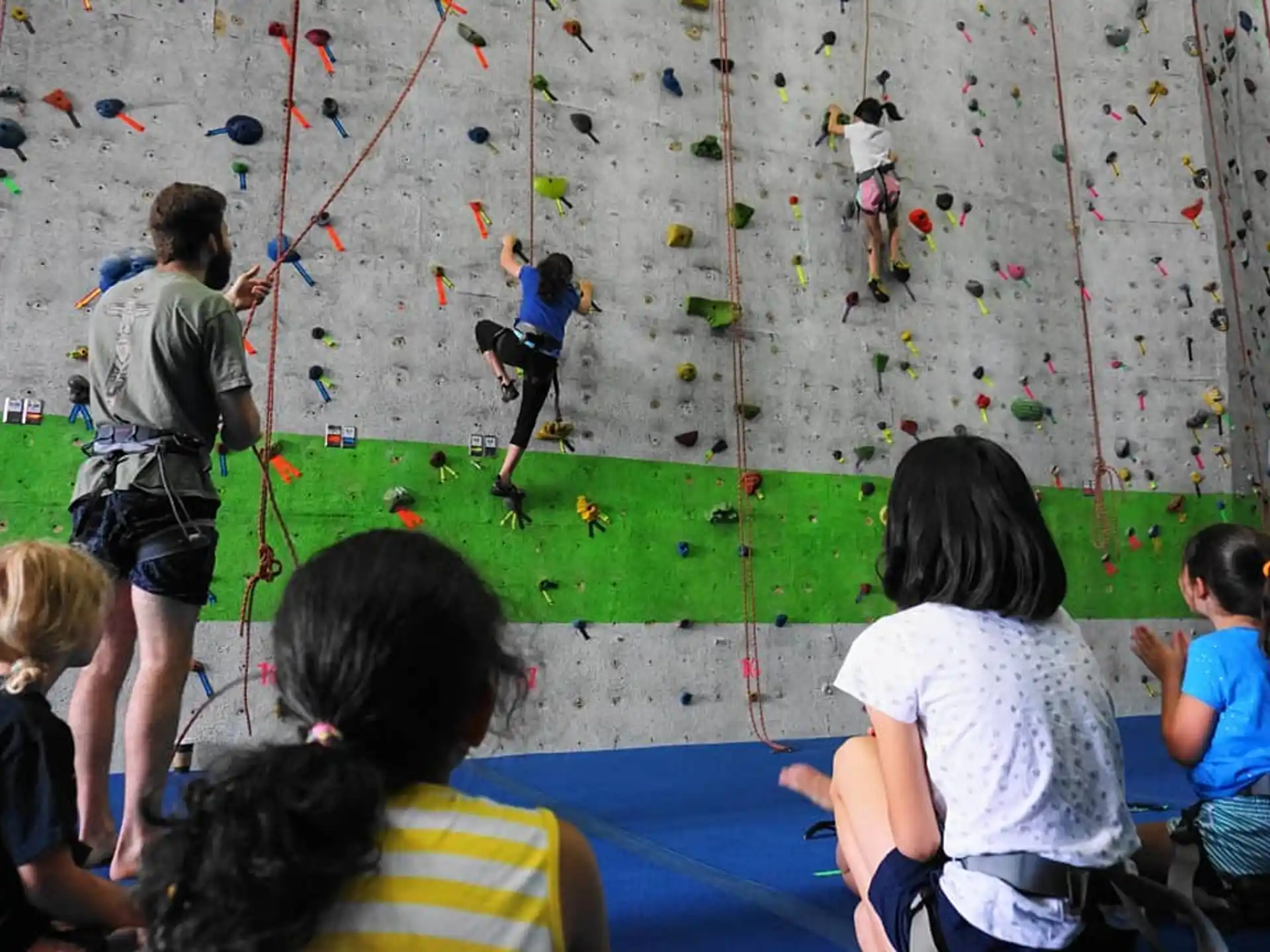 a group of children playing on a wall