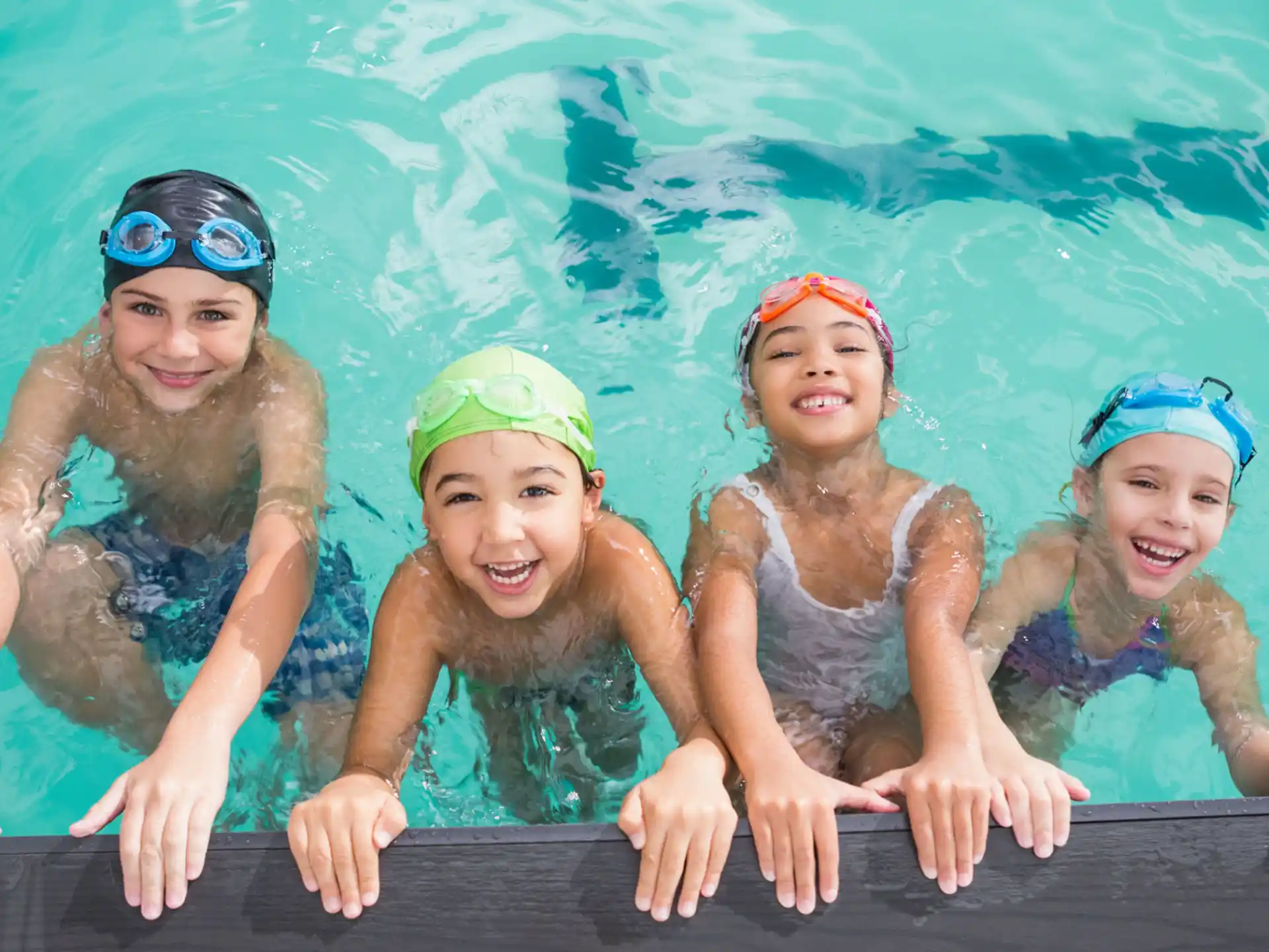 a group of girls in swimsuits in a pool