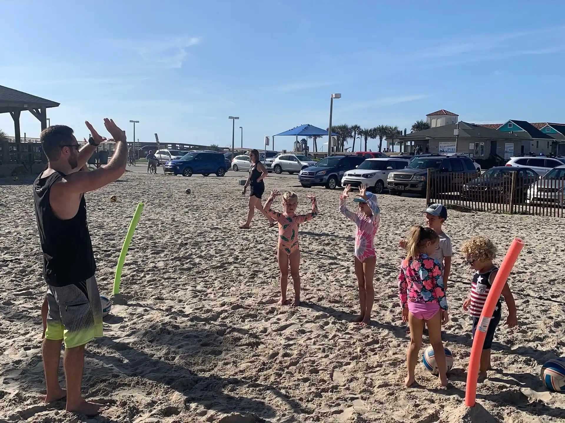 a group of people playing in the sand
