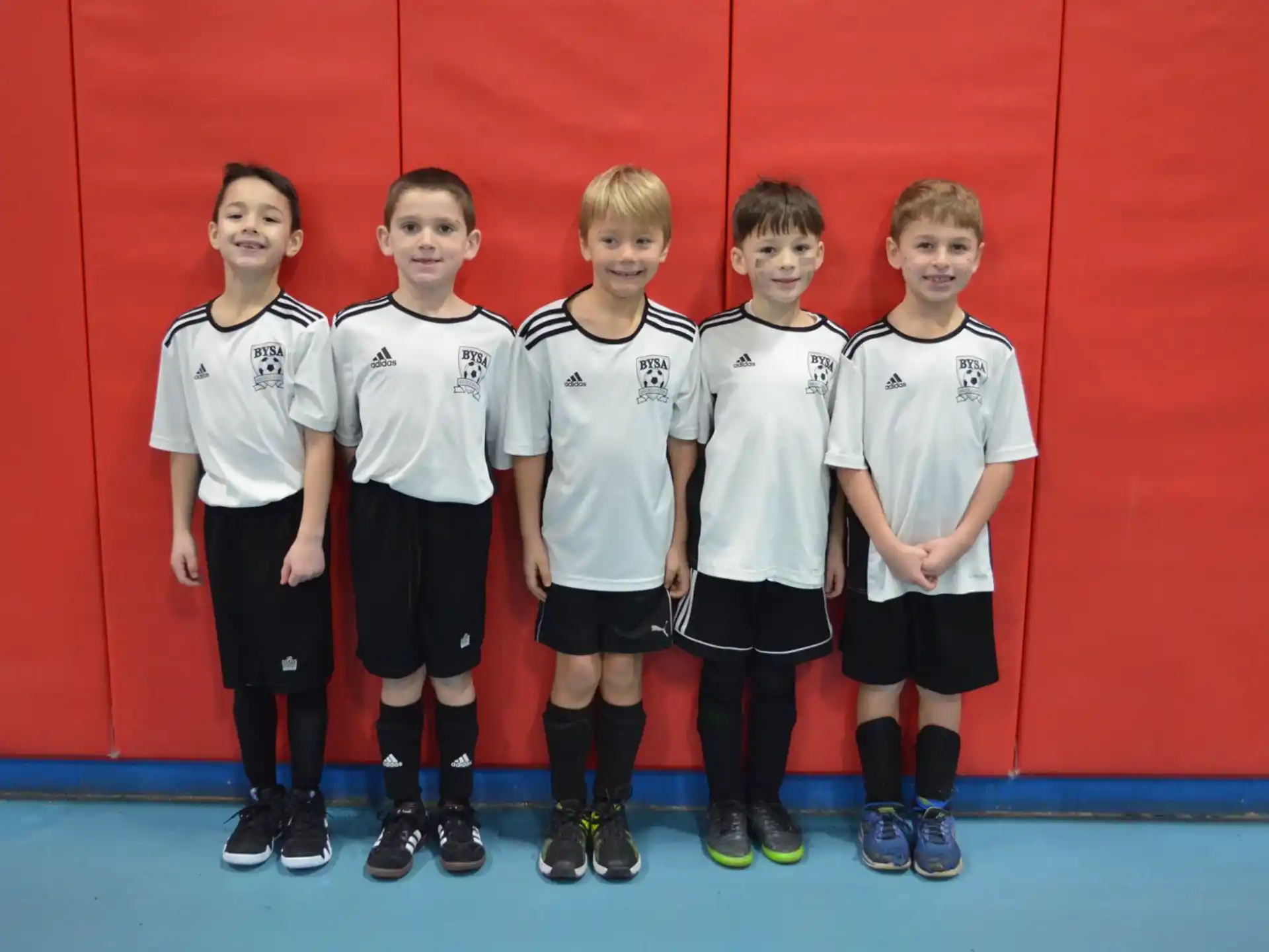 a group of boys in white shirts