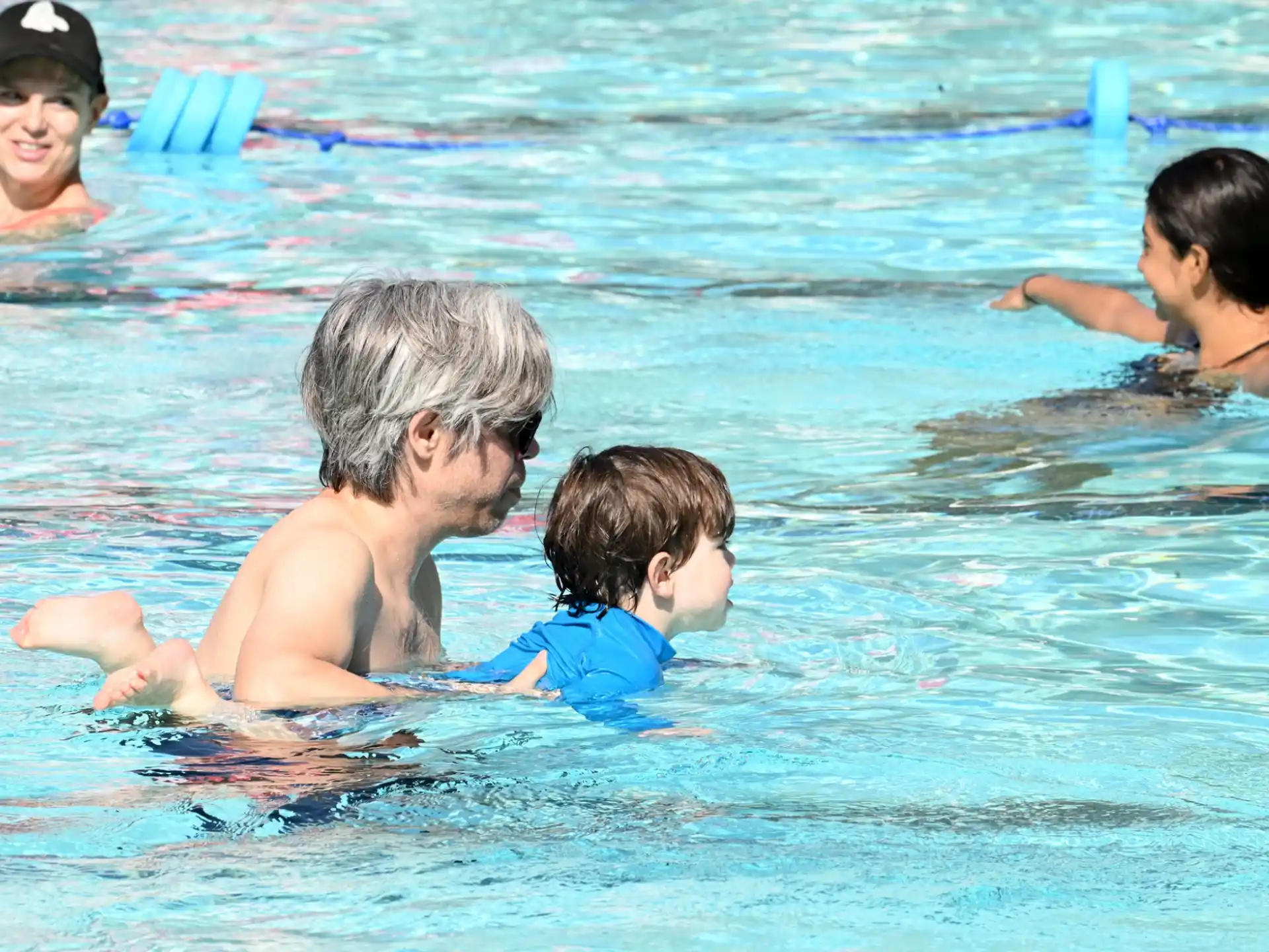 a man and a couple of children in a pool