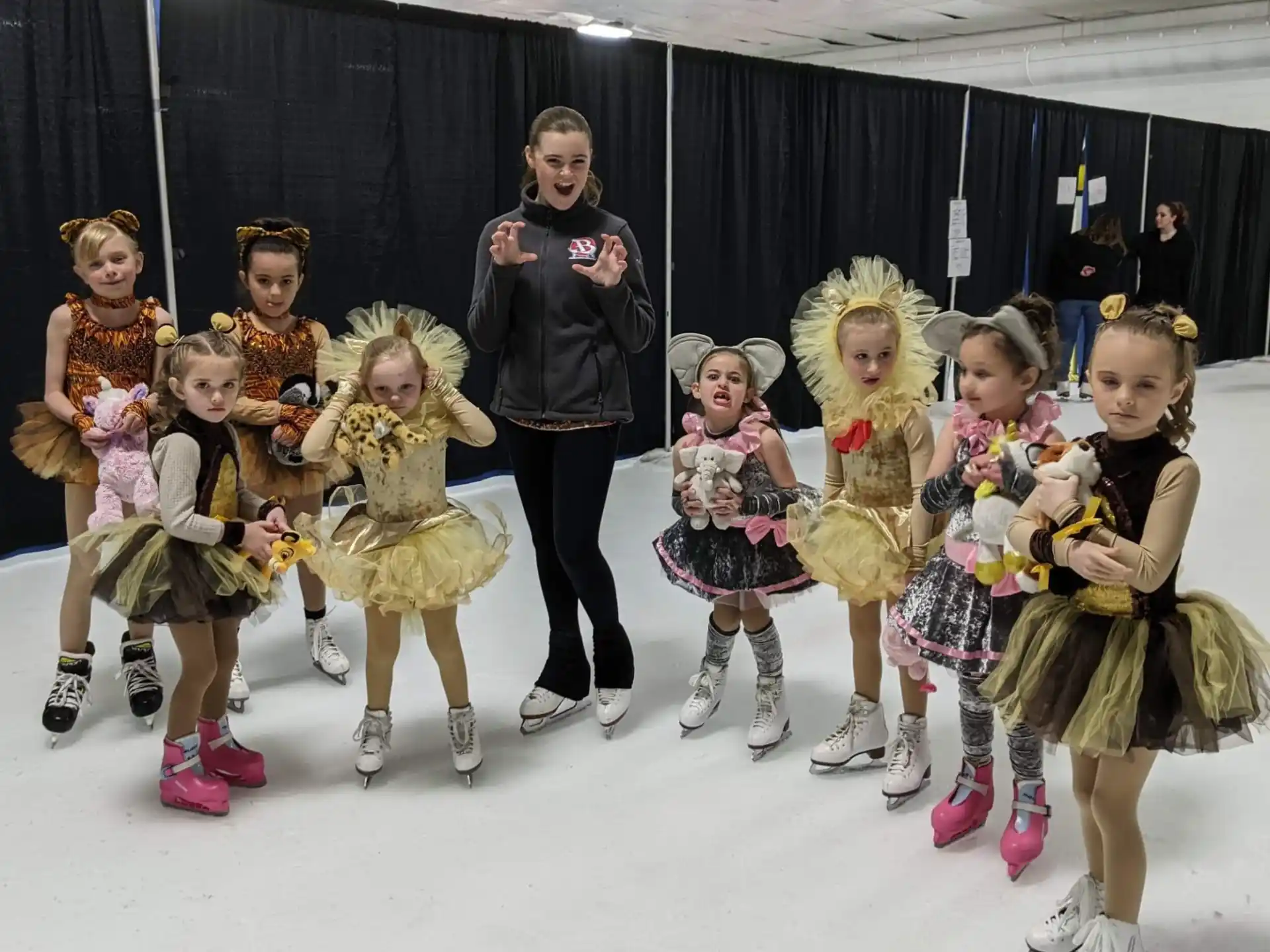 a group of people wearing ice skates posing for the camera