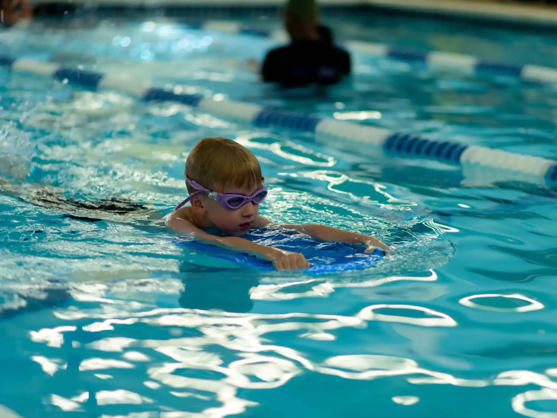 a boy swimming in a pool