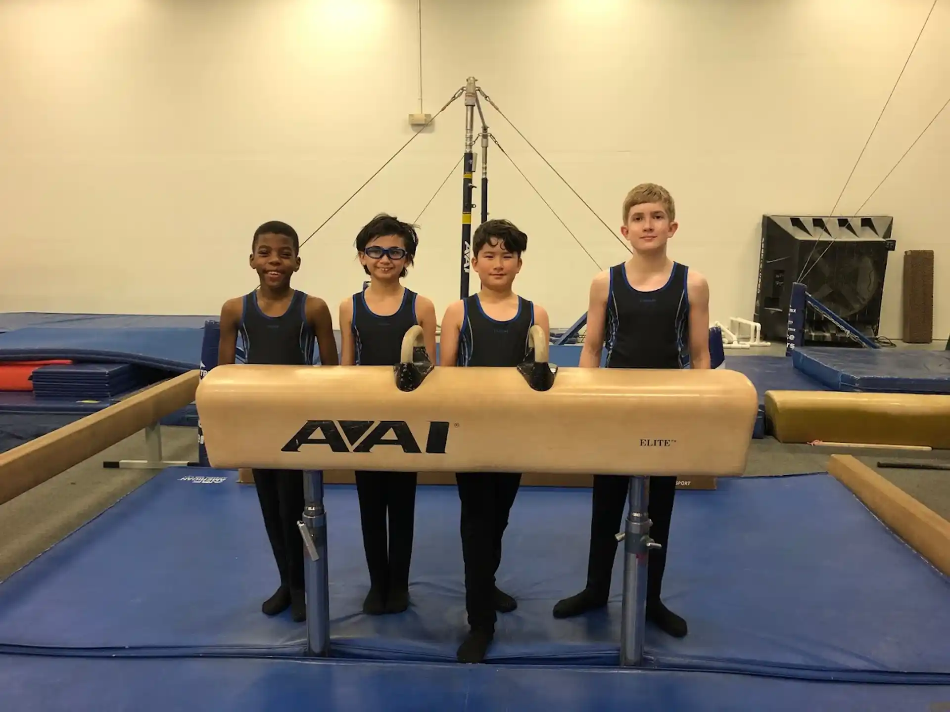 a group of men in black suits holding a large piece of wood