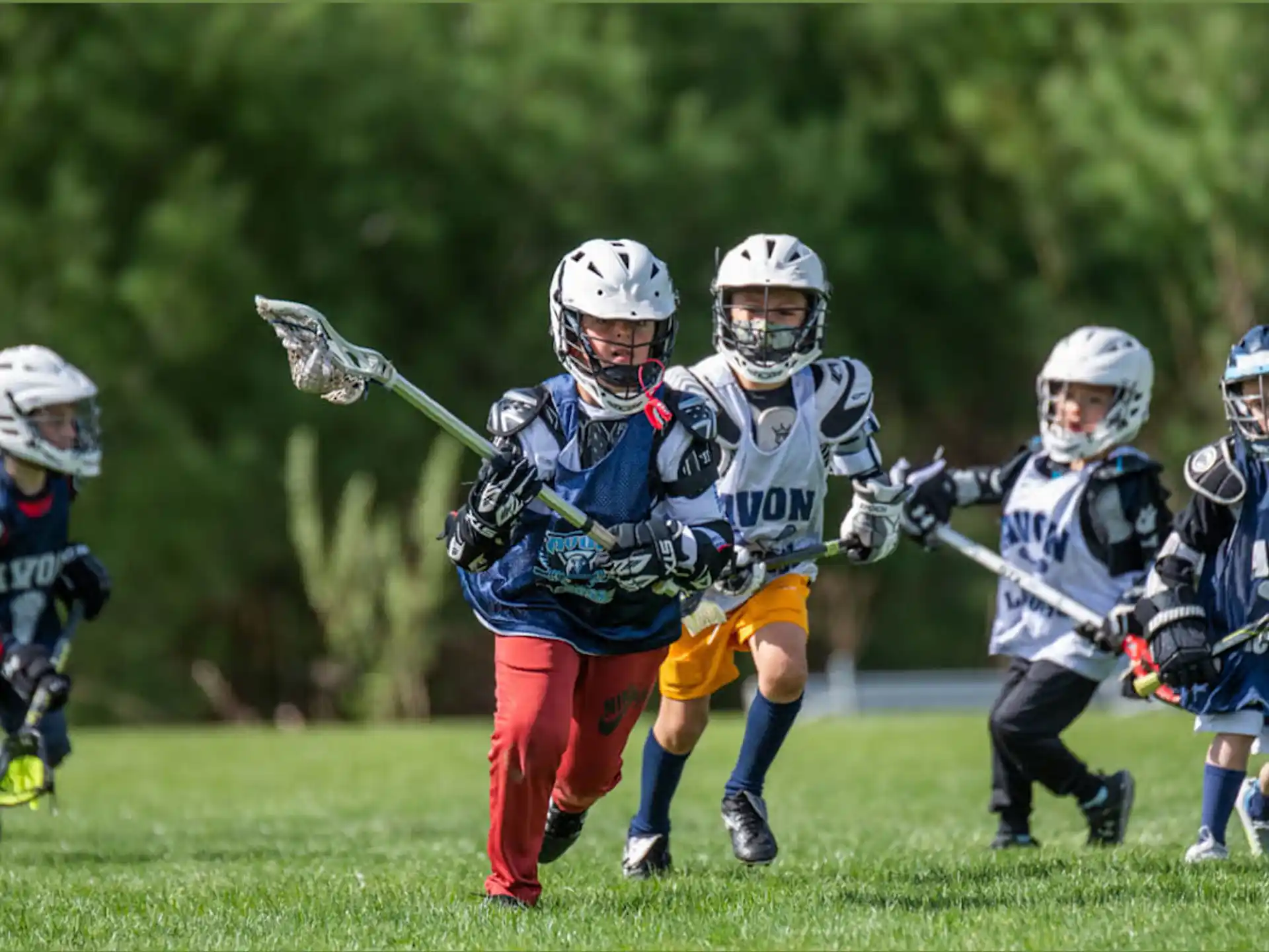 a group of people in helmets holding sticks