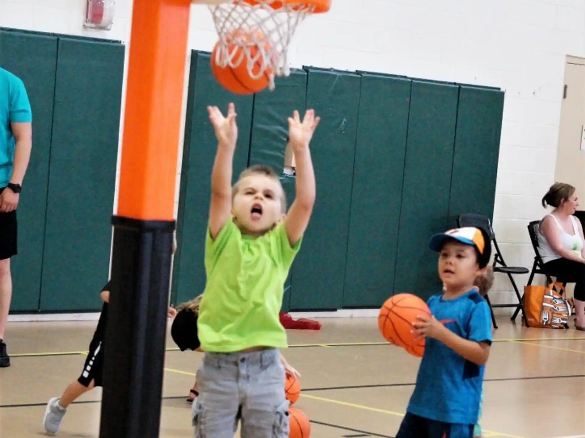 a couple of kids playing basketball