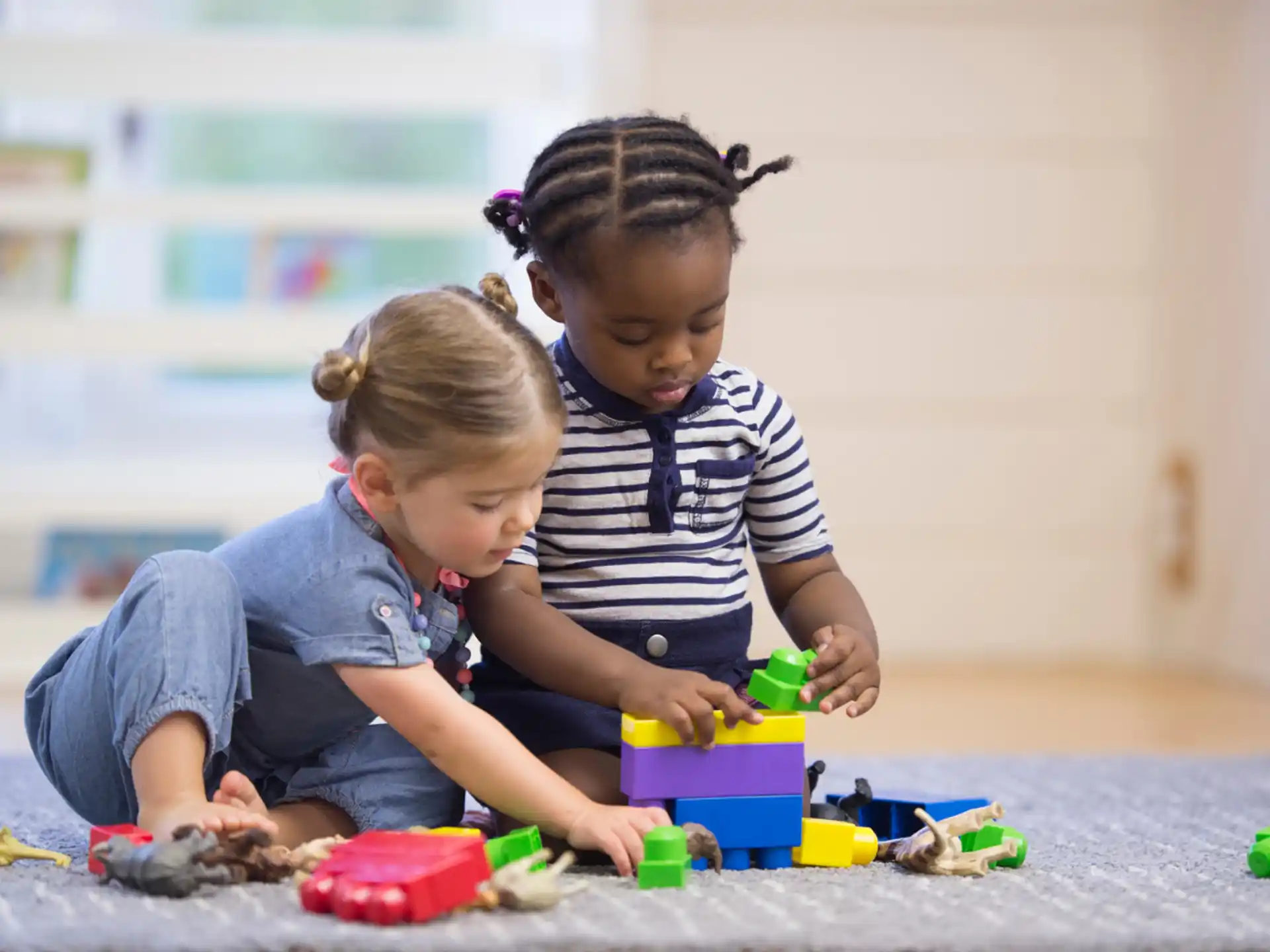 a couple of children playing with toys