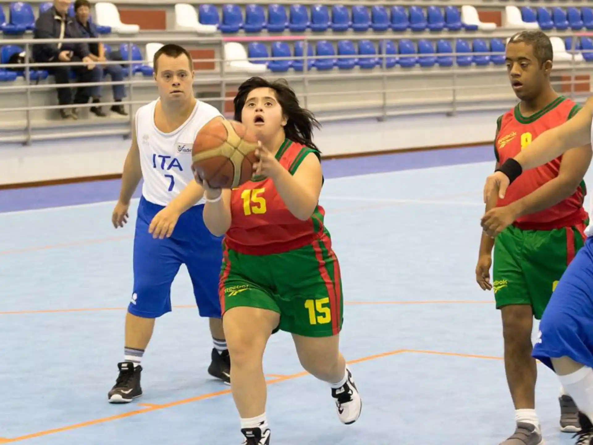 a group of people playing basketball