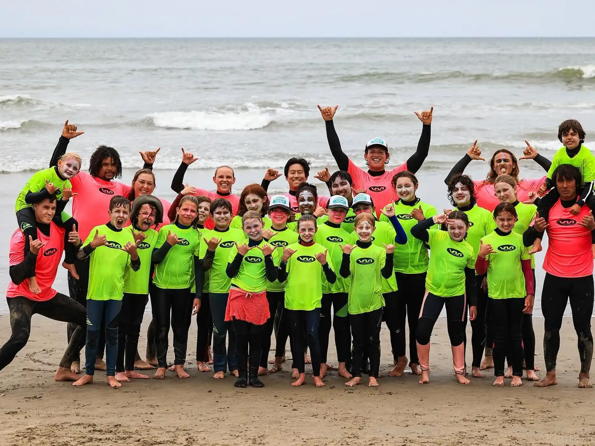 a group of people posing for a photo on a beach
