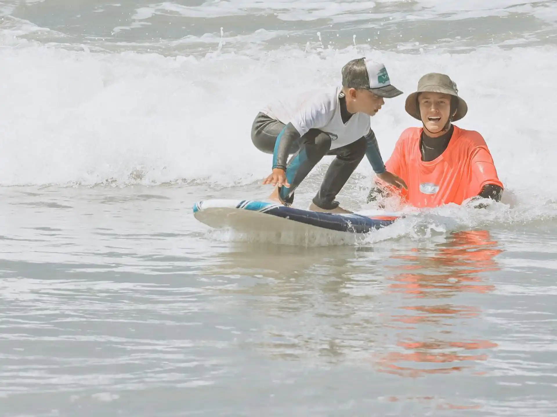 a person and a boy surfing