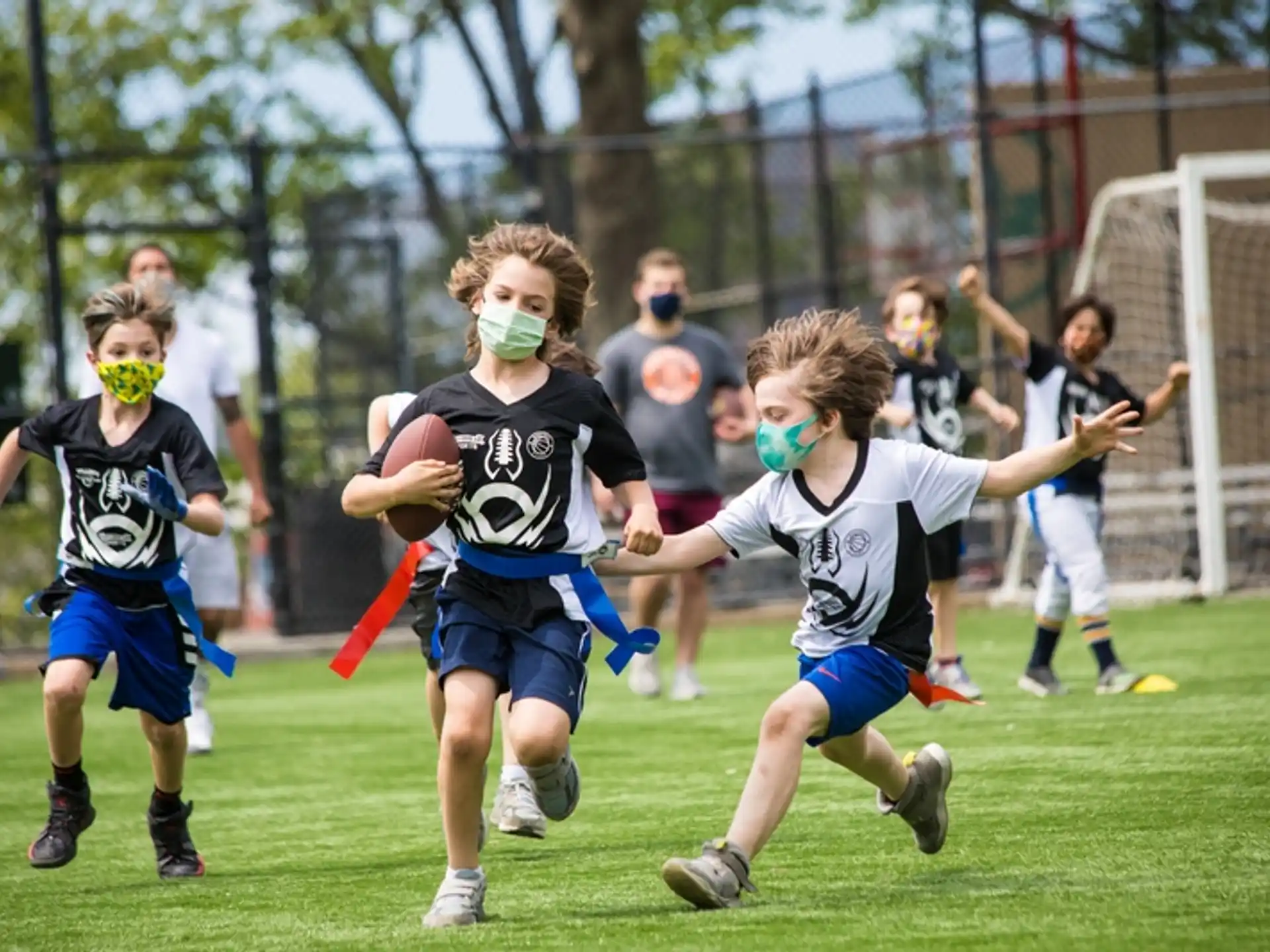 a group of kids playing football
