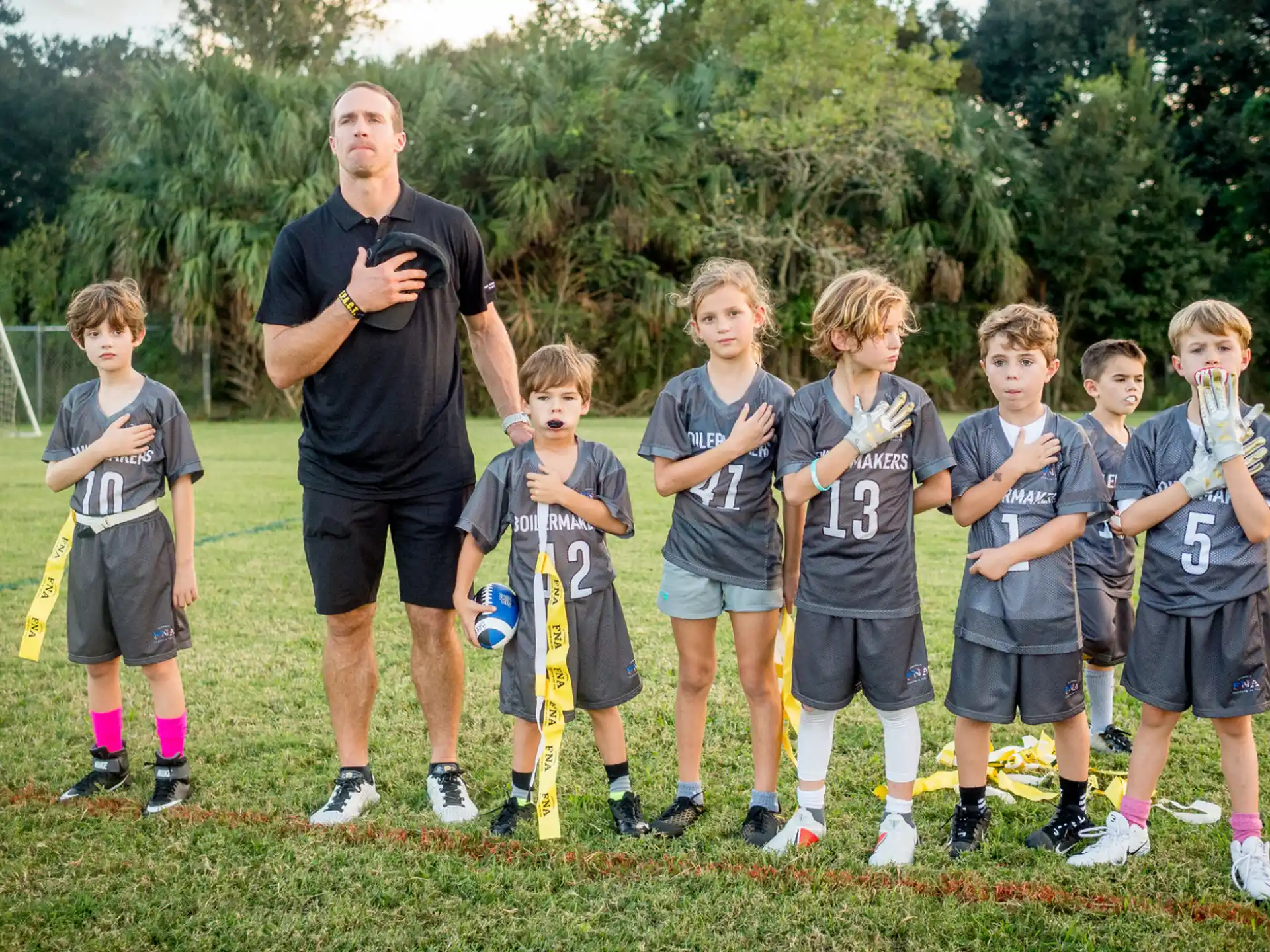 a group of kids standing on a field