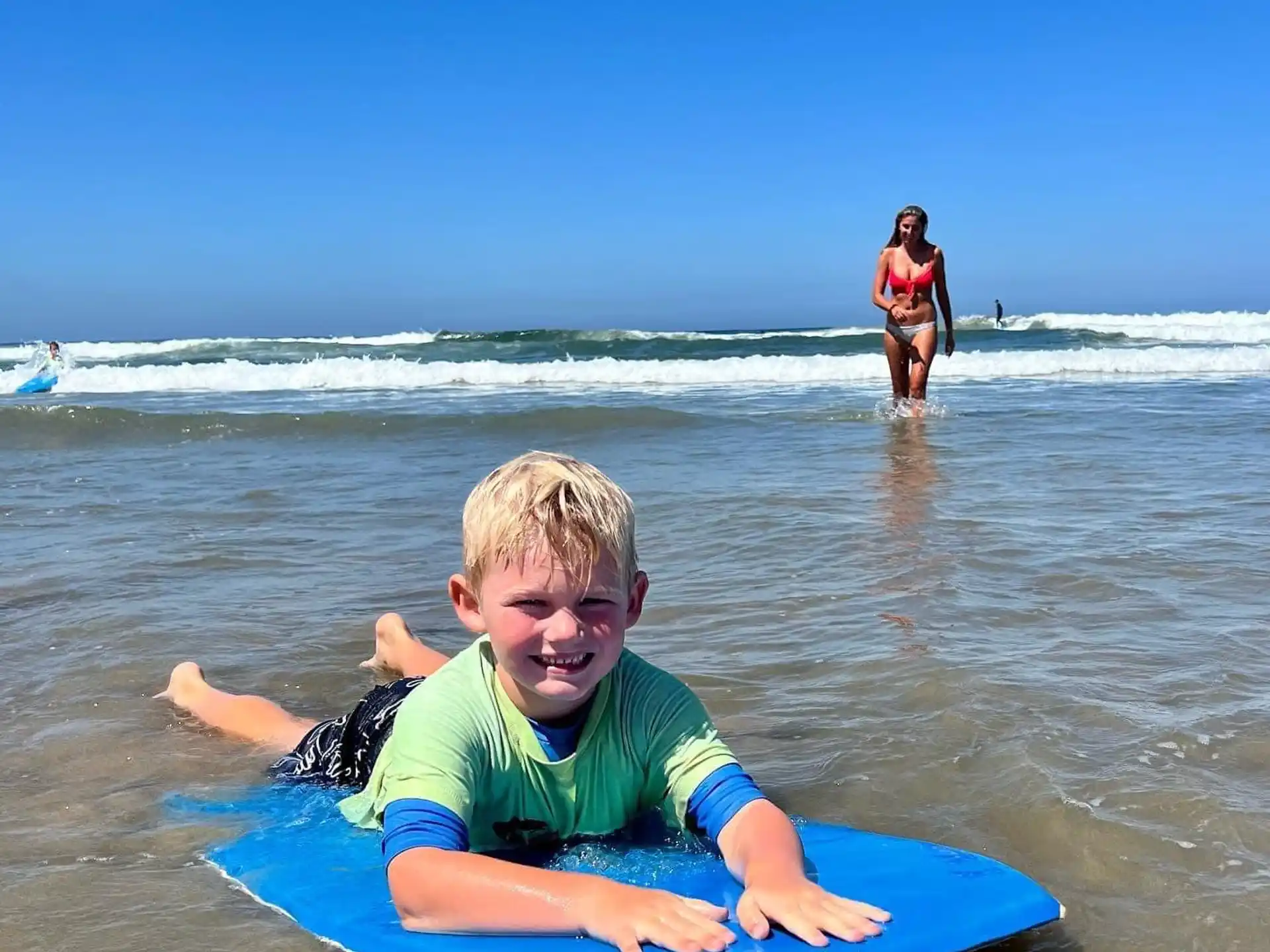 a boy on a surfboard in the ocean