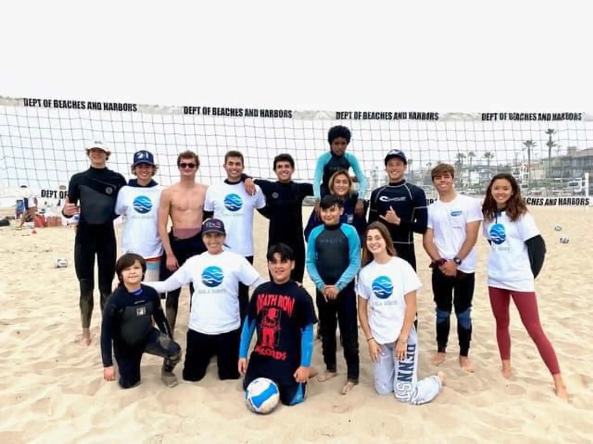 a group of people posing for a photo on a beach