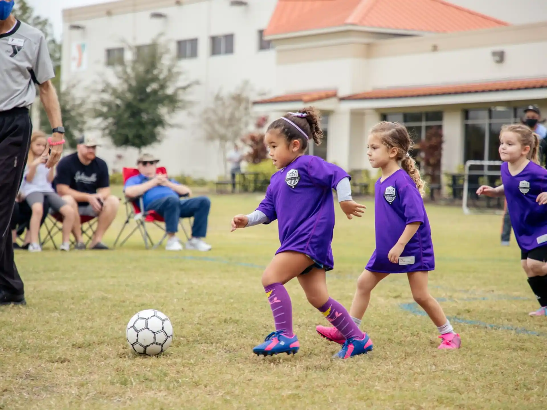girls playing football on a field