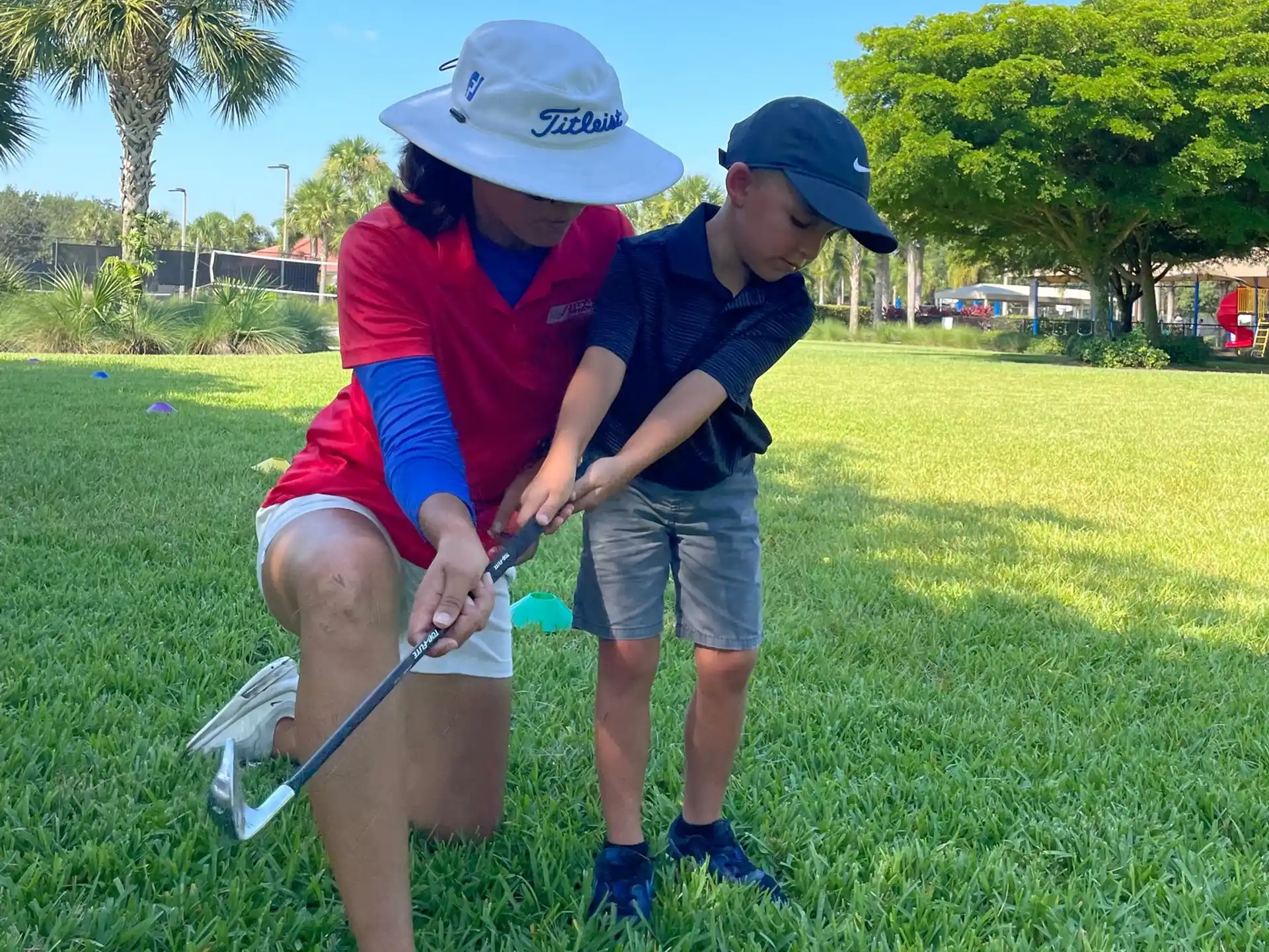 a person and a boy playing golf