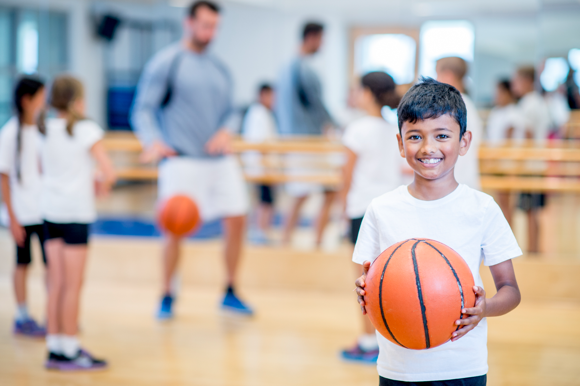 a boy holding a basketball