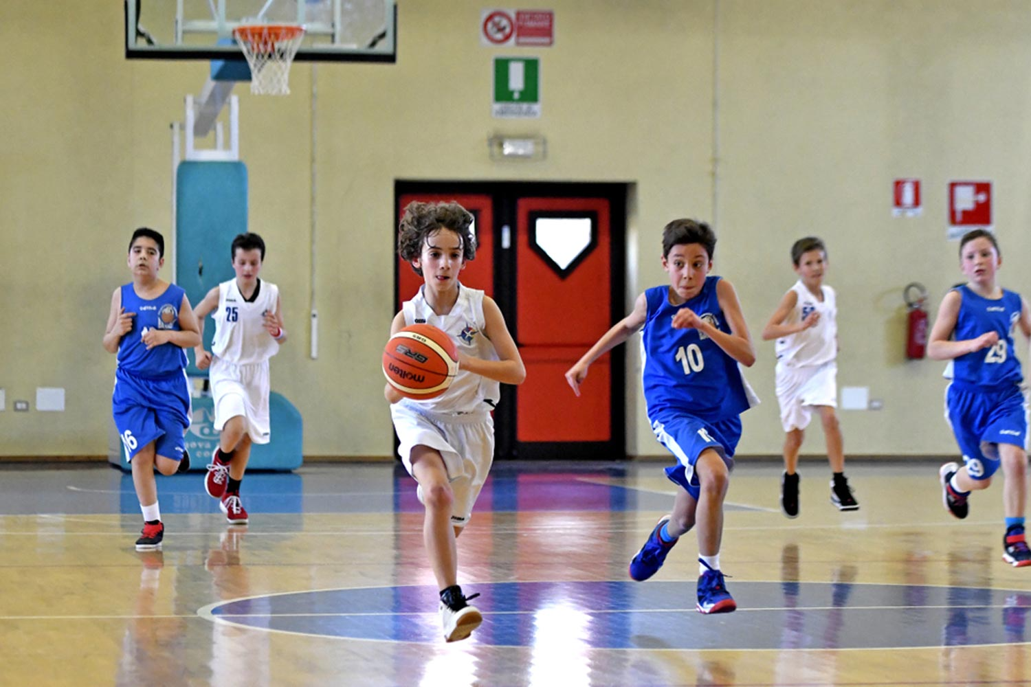 a group of kids playing basketball