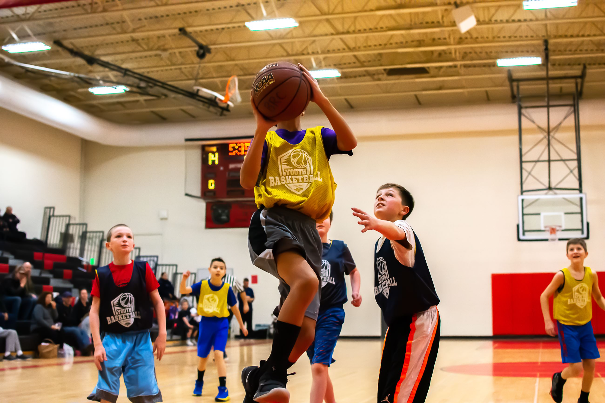 a group of people playing basketball