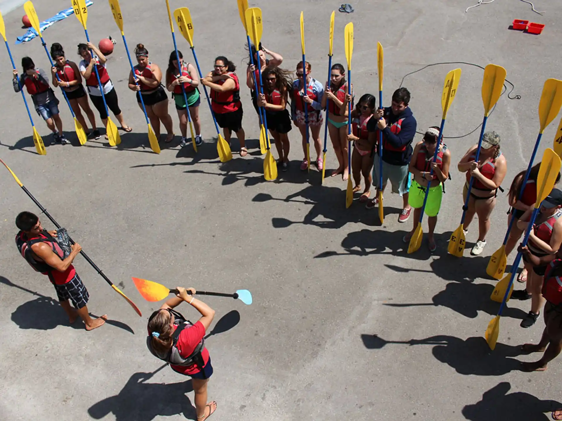 a group of people holding up yellow and black sticks