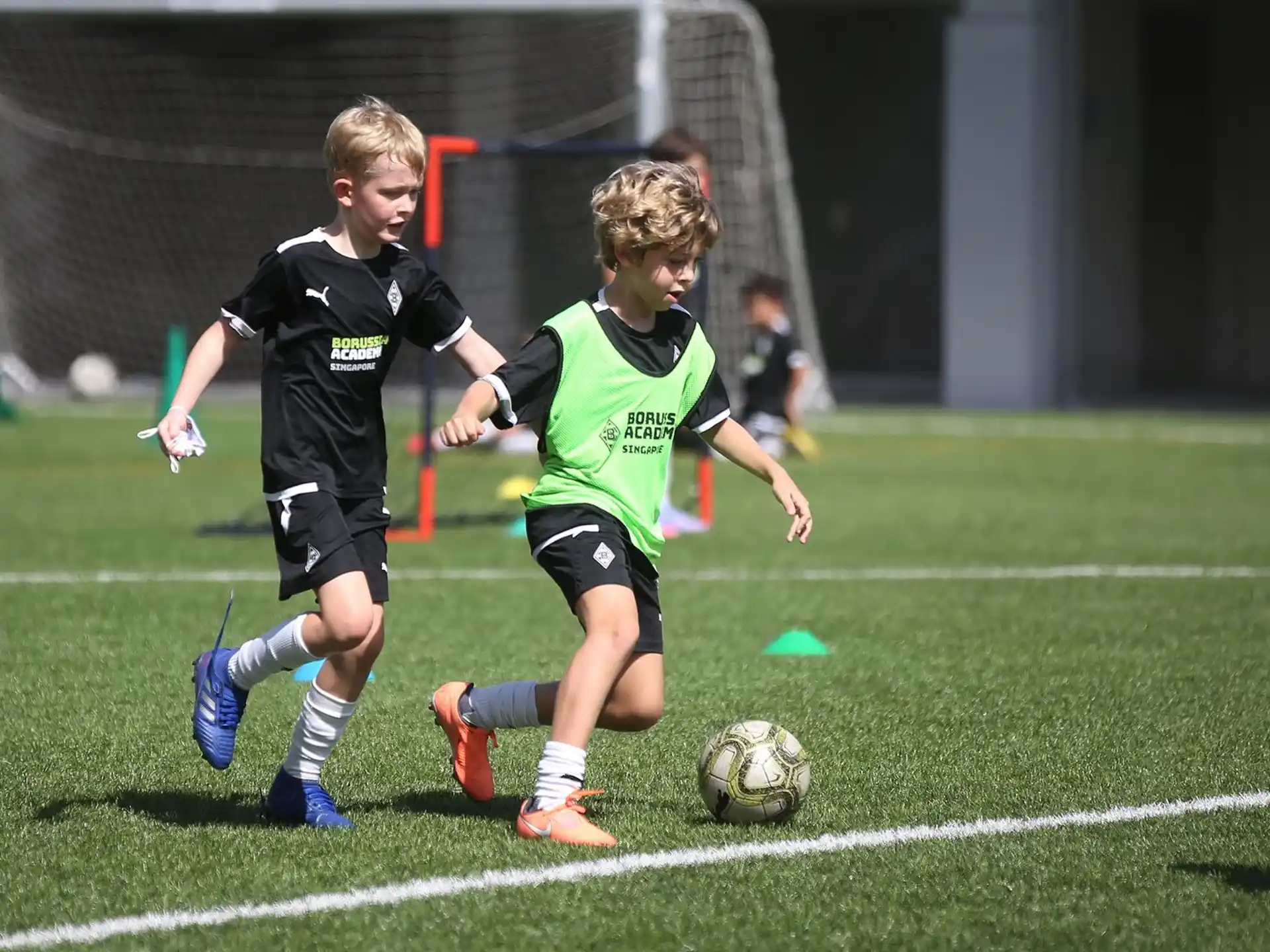 kids chasing a football ball