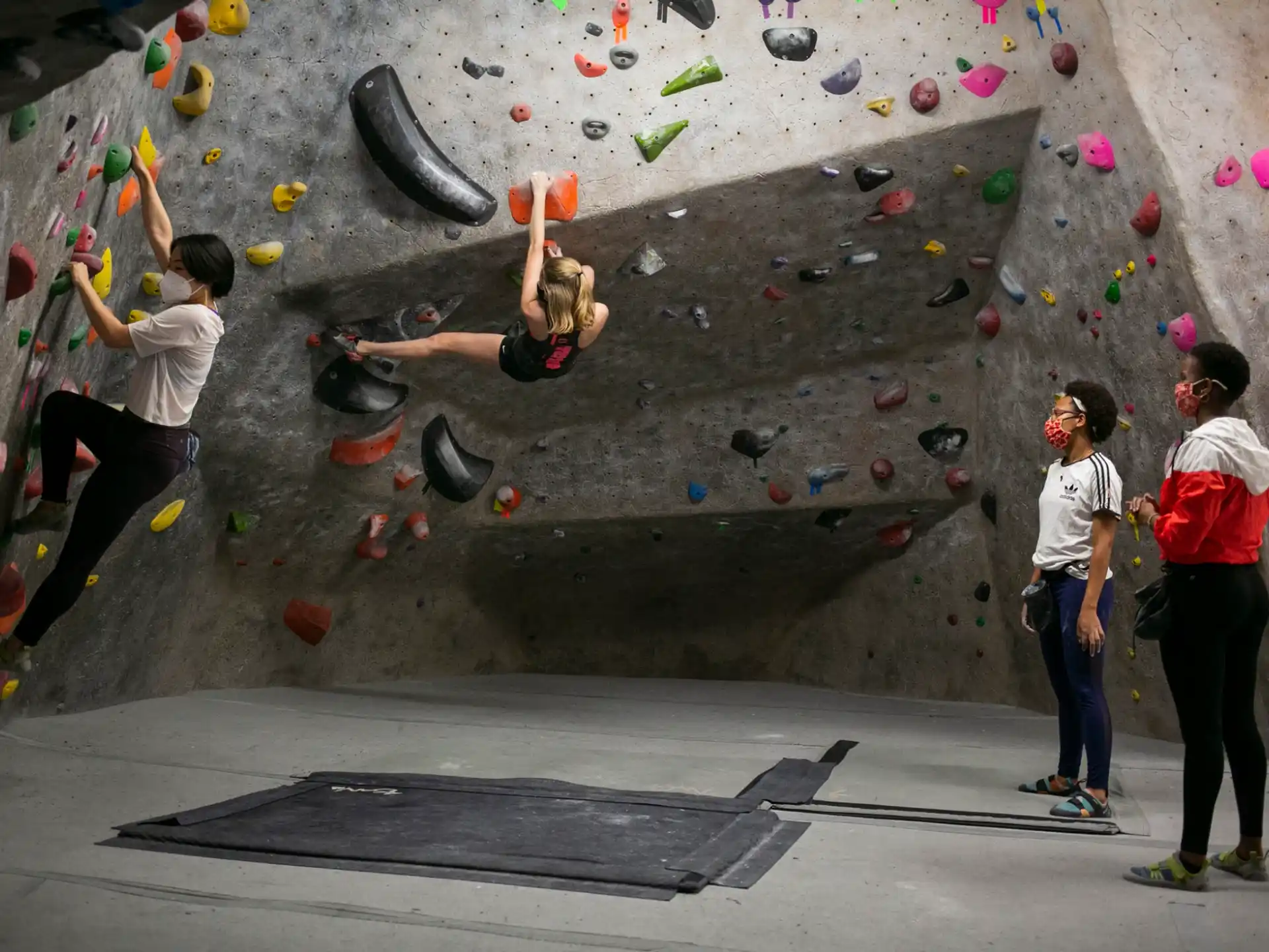 a group of people climbing a rock wall