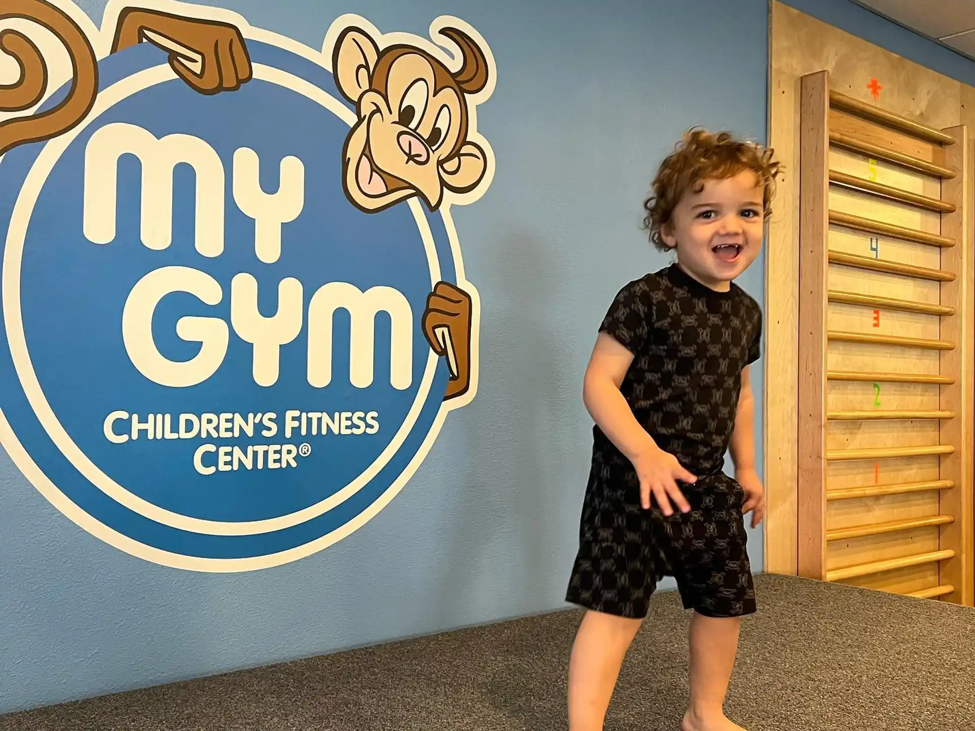 a child standing in front of a sign