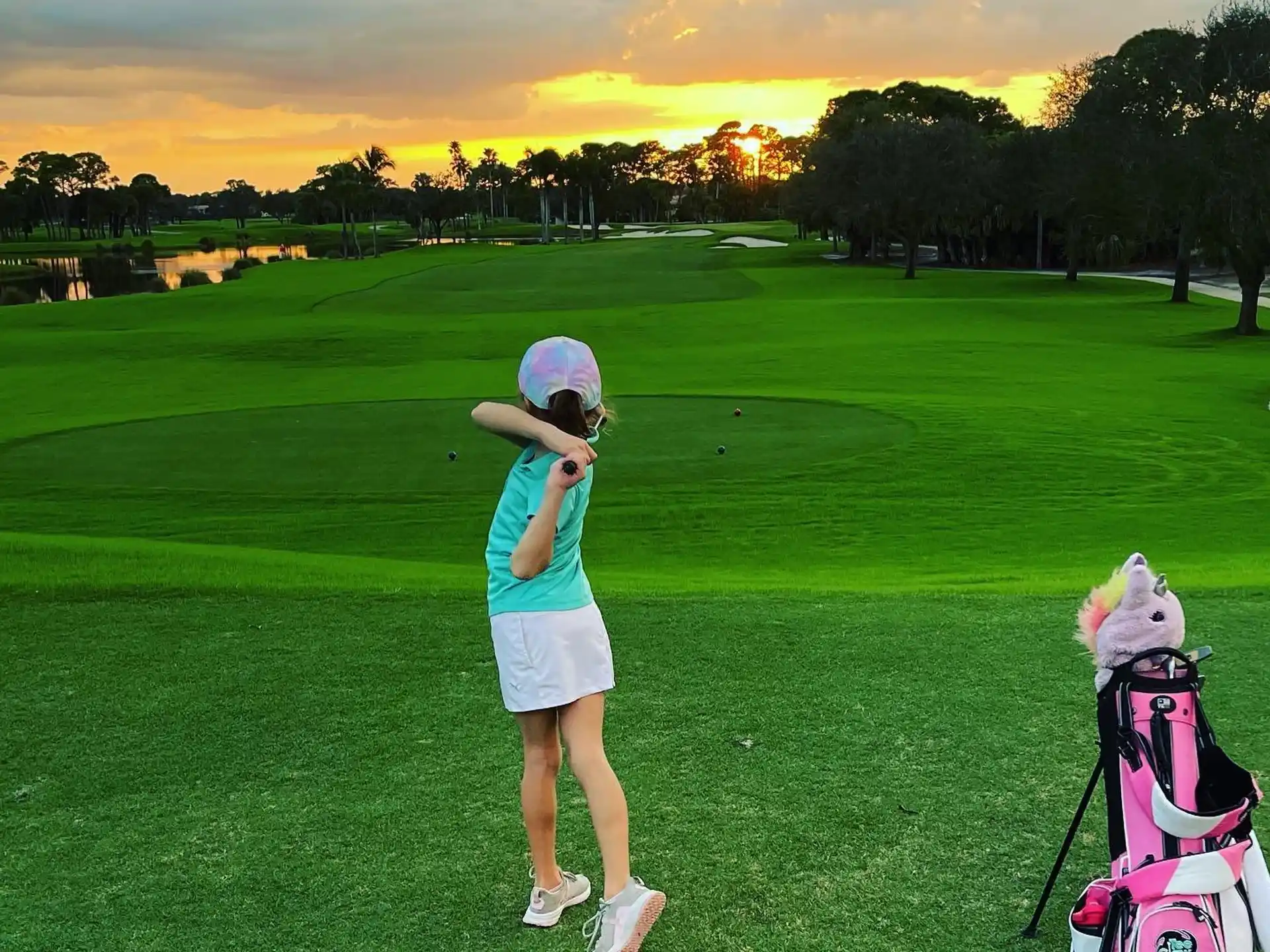 a person taking a picture of a dog on a golf course