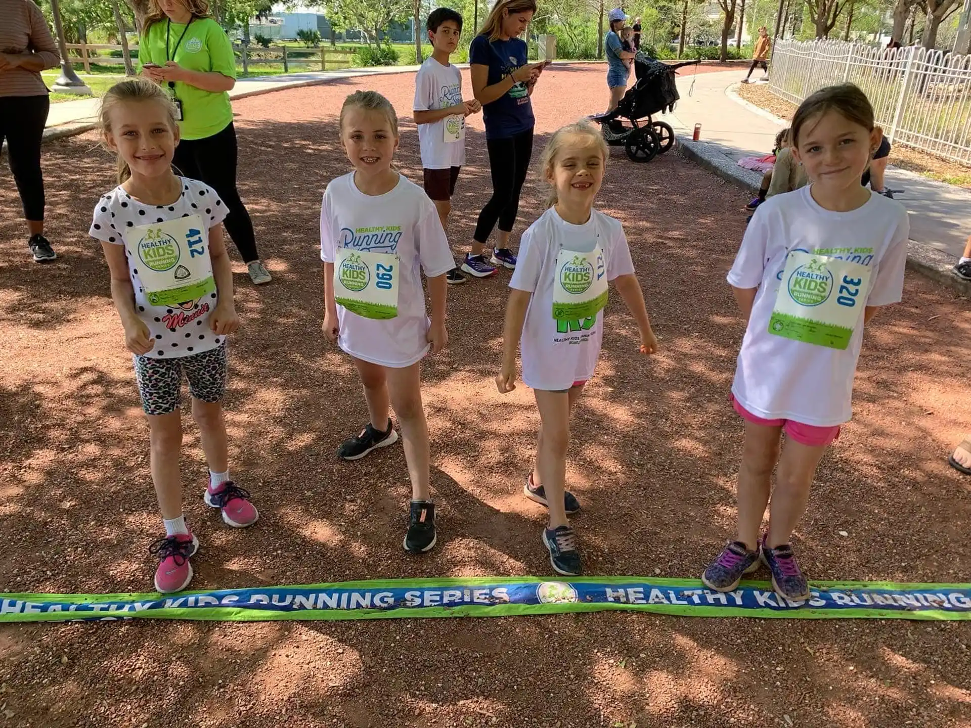a group of children standing on a track
