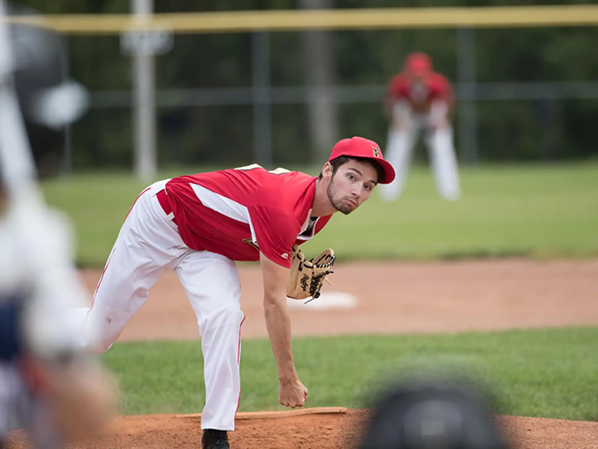 a baseball player pitching a ball