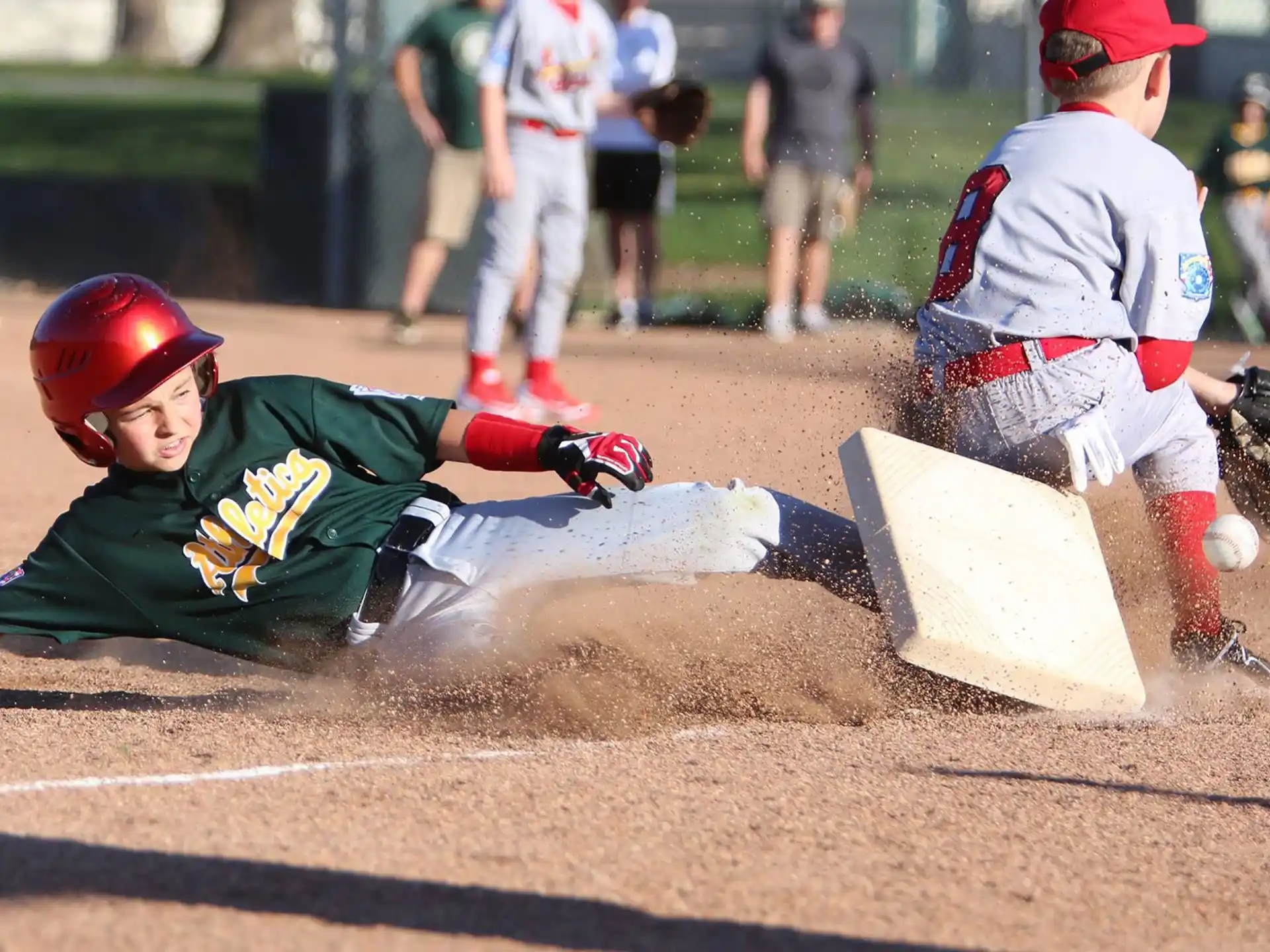 a baseball player sliding into home plate
