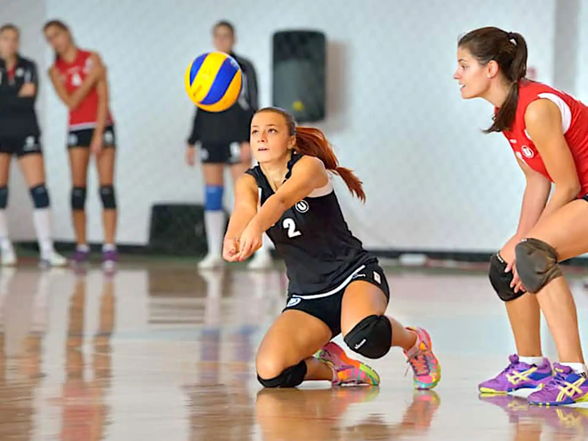 a group of women playing volleyball